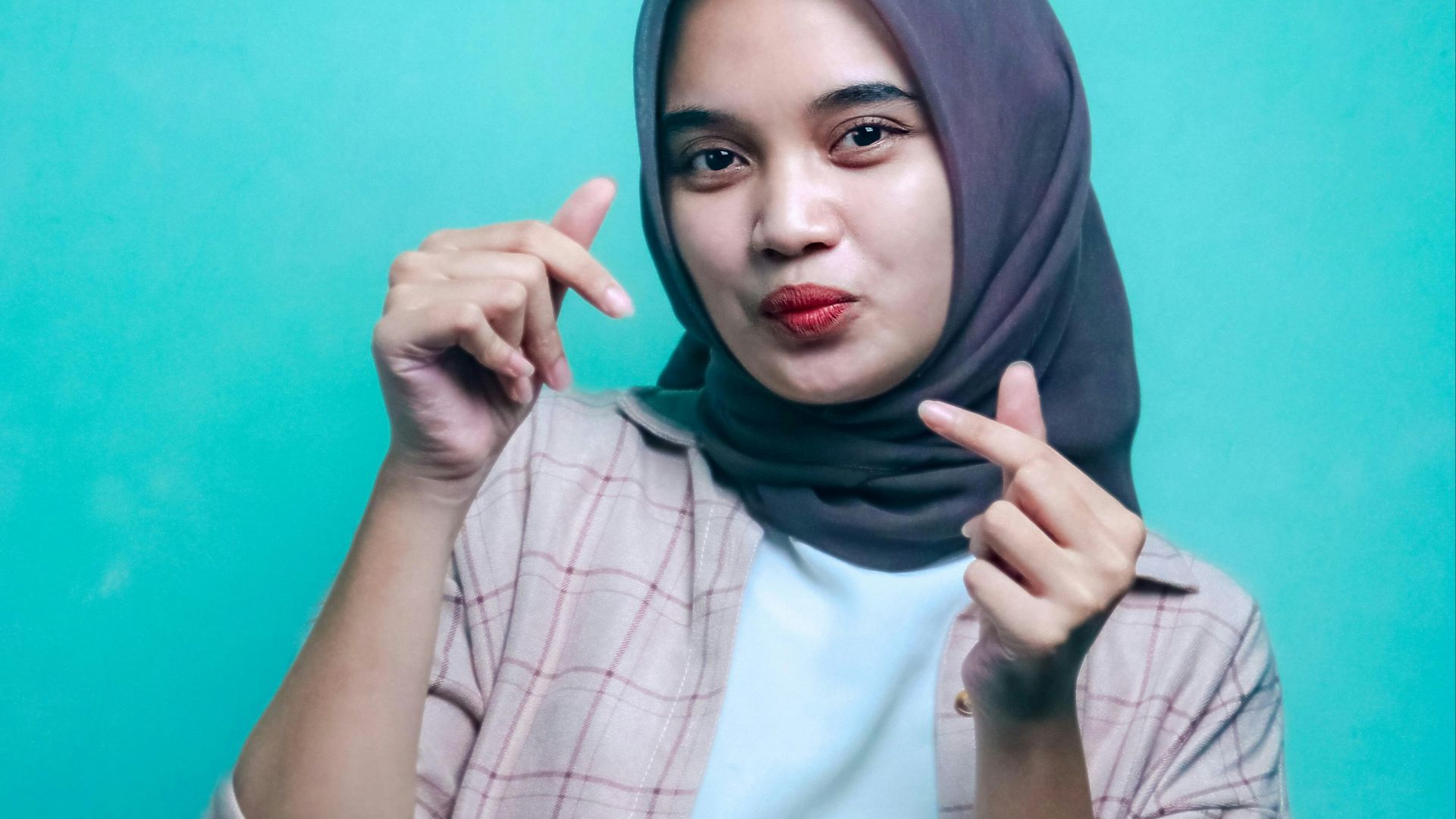 woman in gray hijab and white and black plaid long sleeve shirt