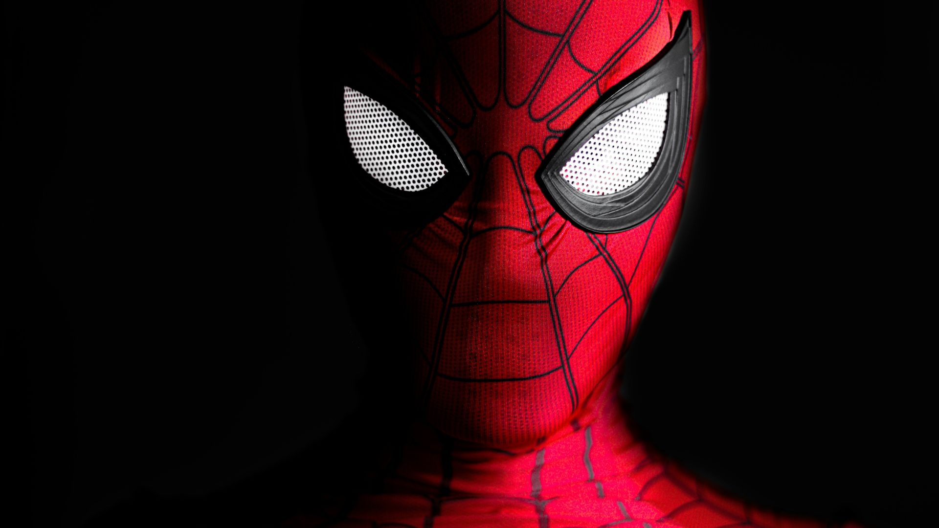 a close up of a spider man with glowing eyes