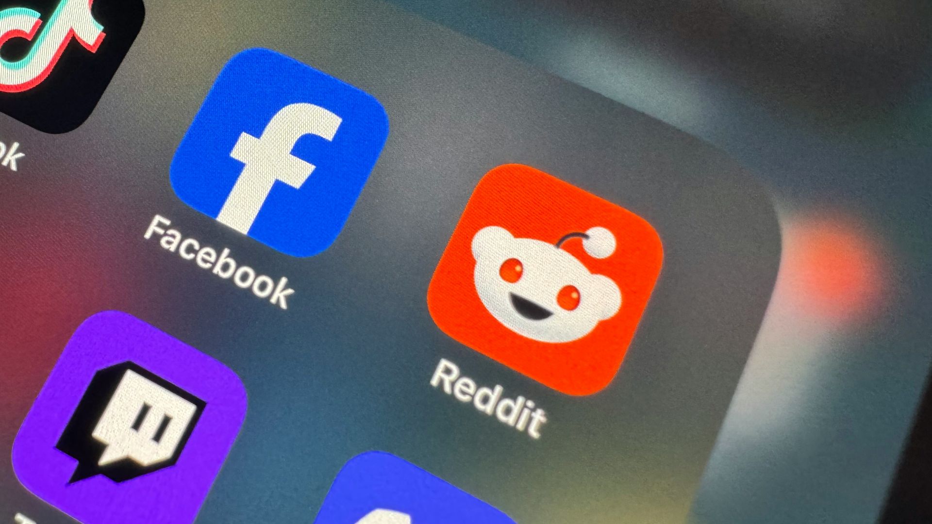 a close up of a cell phone with social icons on it