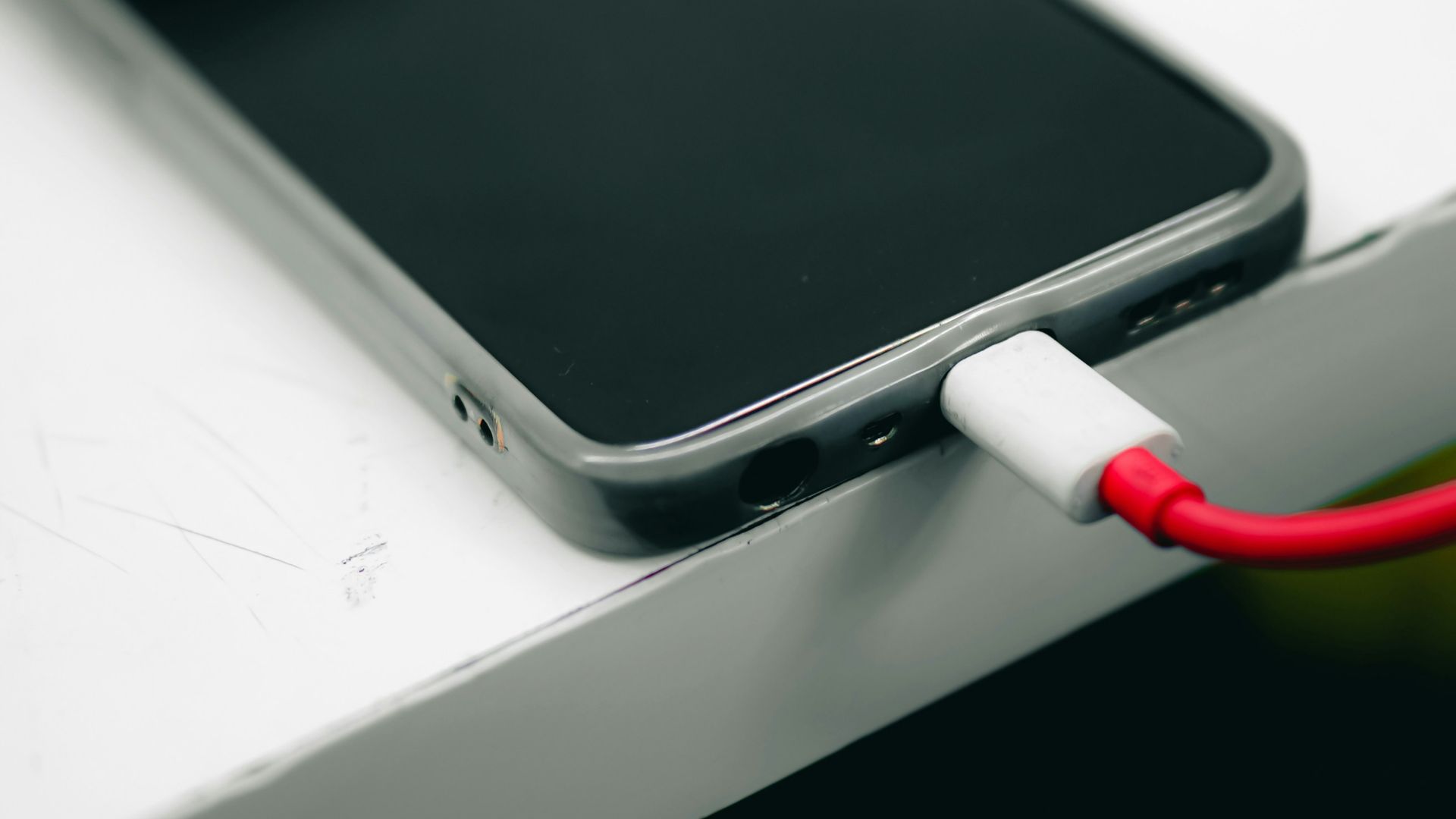 a cell phone is plugged into a charger