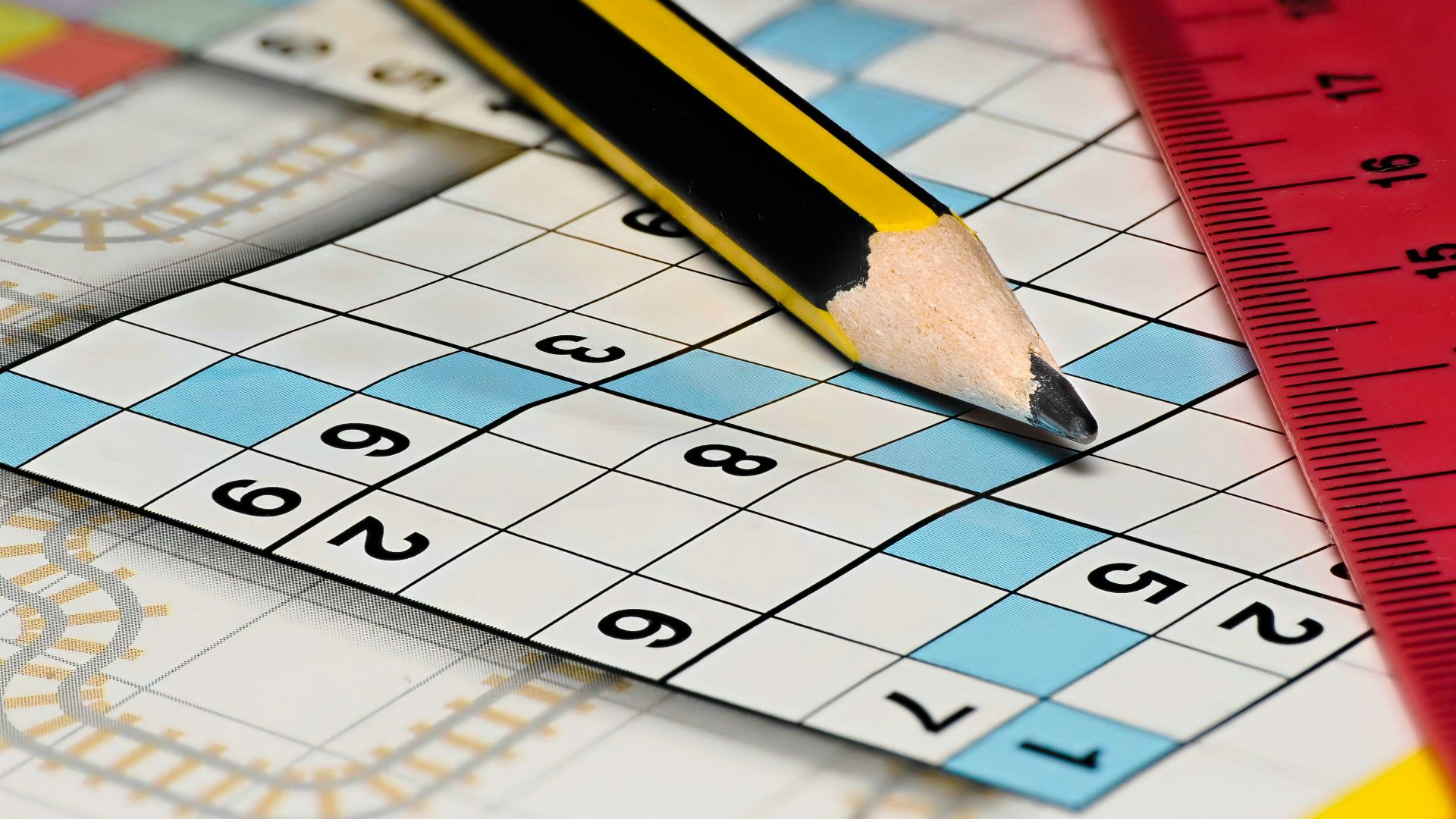 A pencil sitting on top of a piece of paper next to a ruler