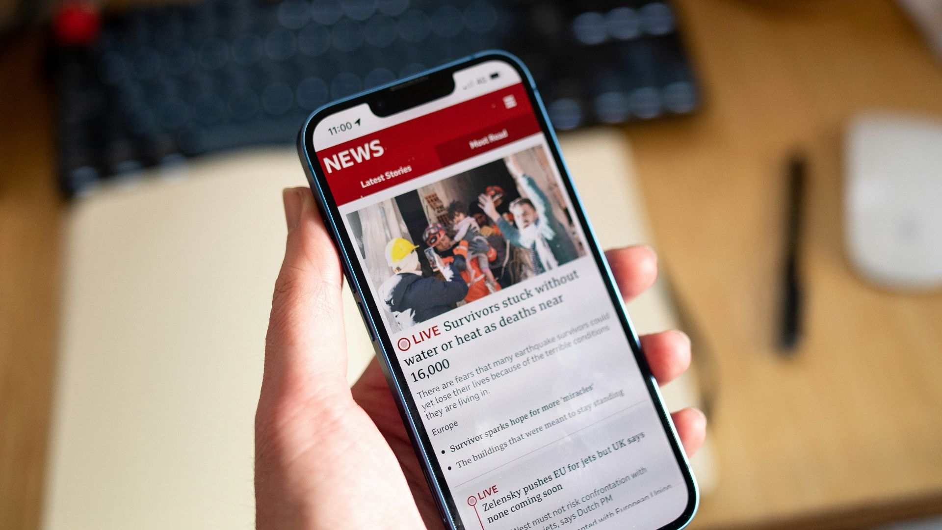 a person holding a cell phone in their hand