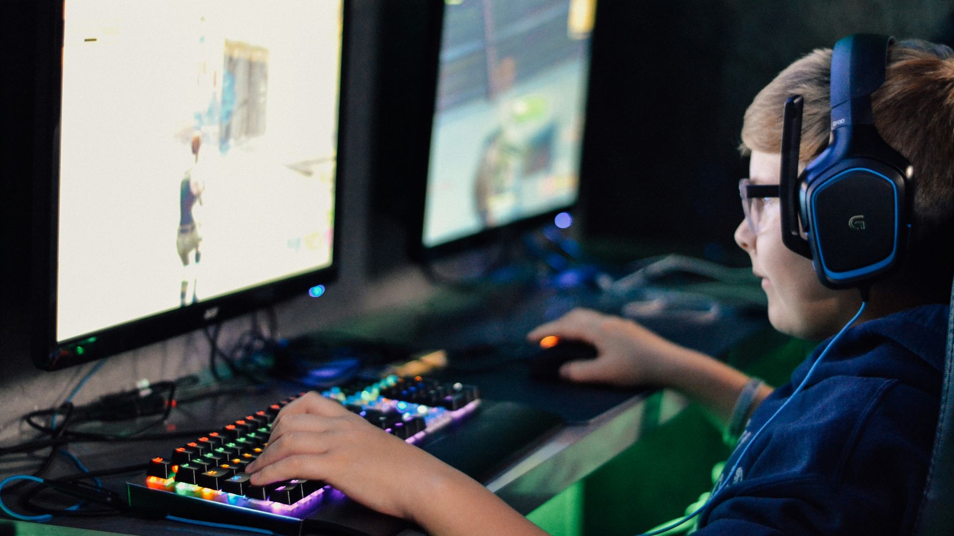 boy wearing headset playing computer game