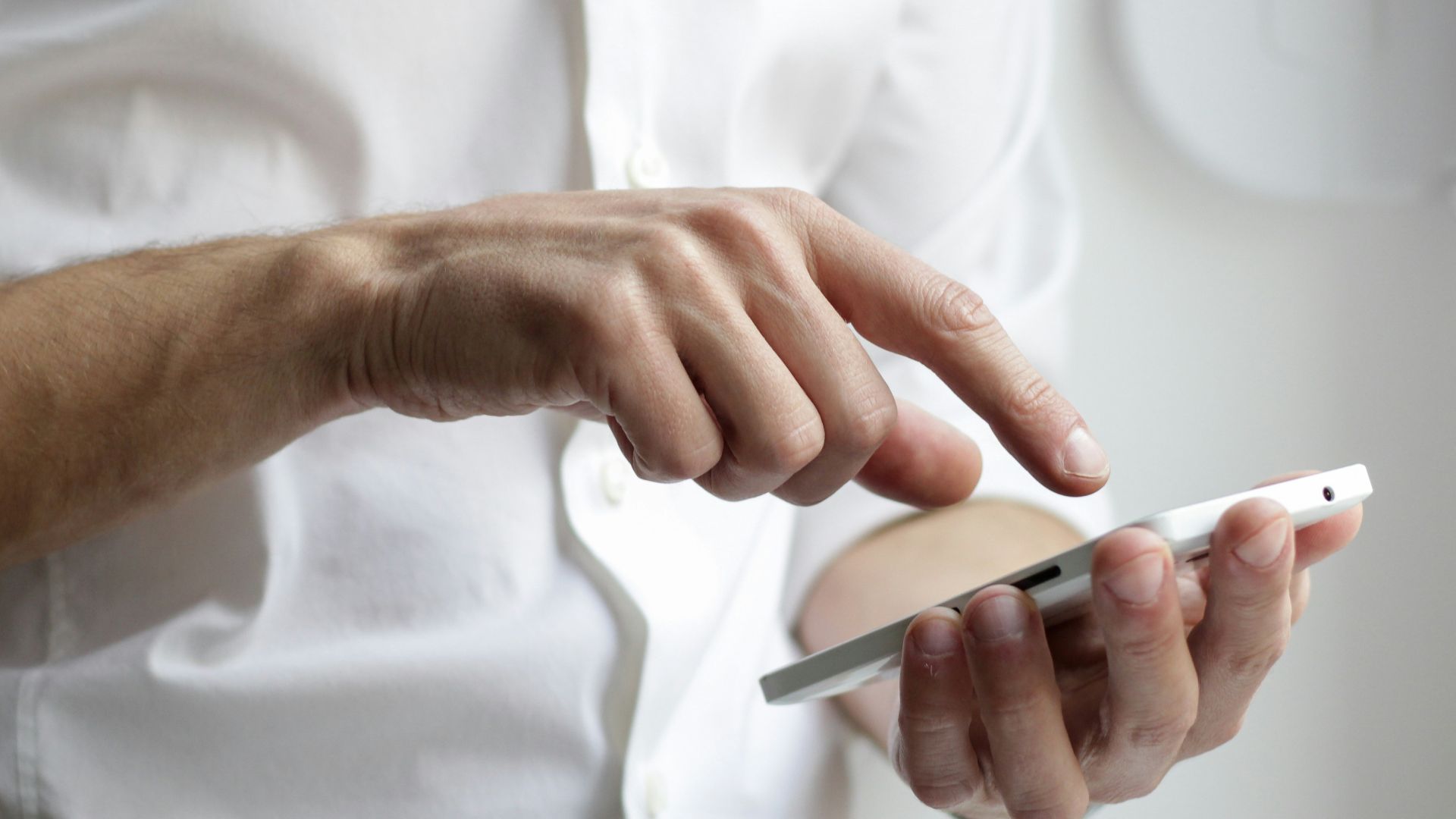 person holding white Android smartphone in white shirt