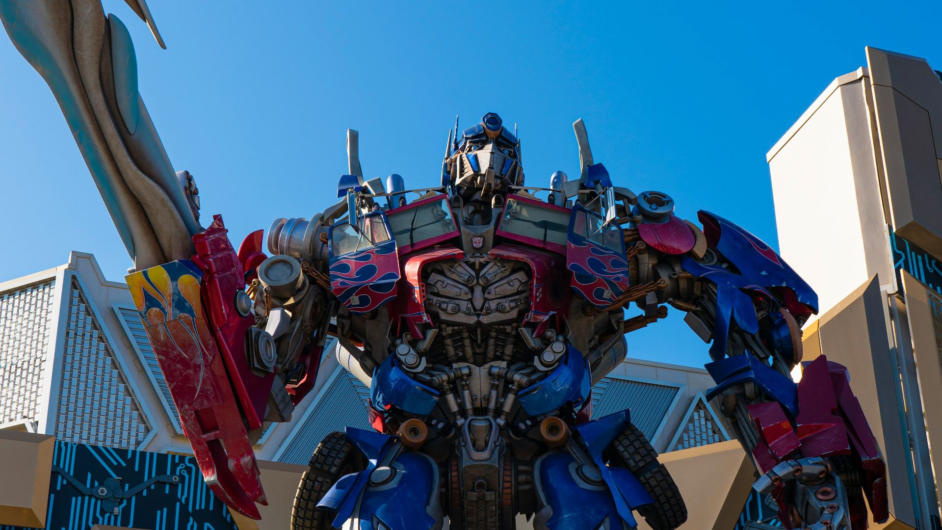 a statue of a giant robot standing in front of a building