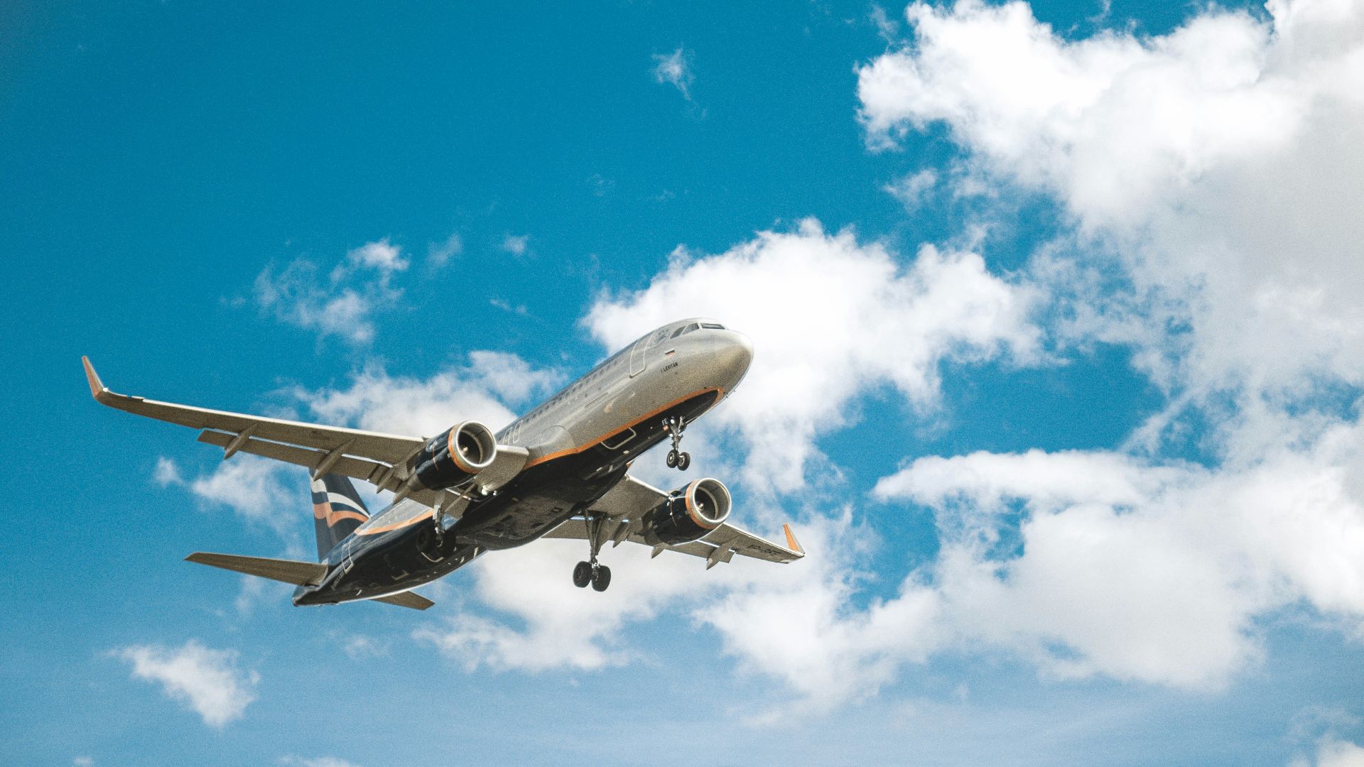 white airplane under blue sky during daytime
