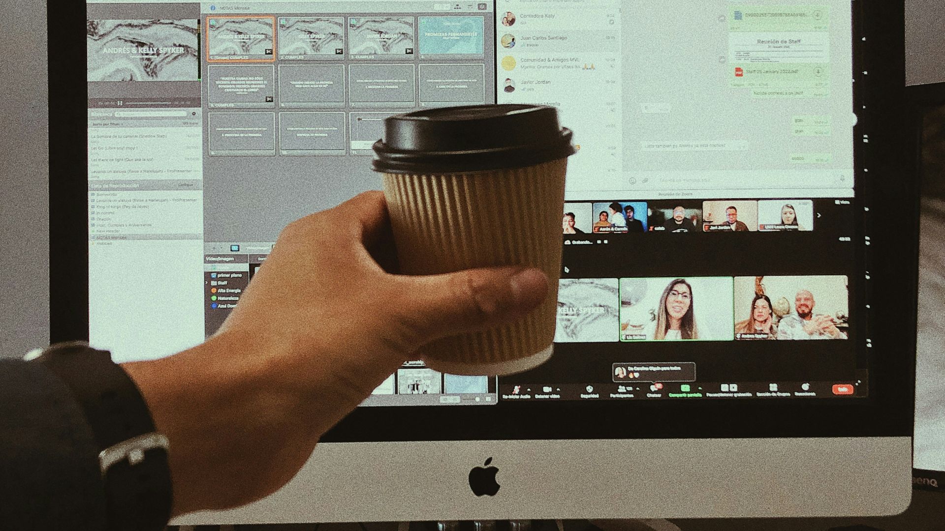 a person sitting at a desk with a monitor keyboard and mouse