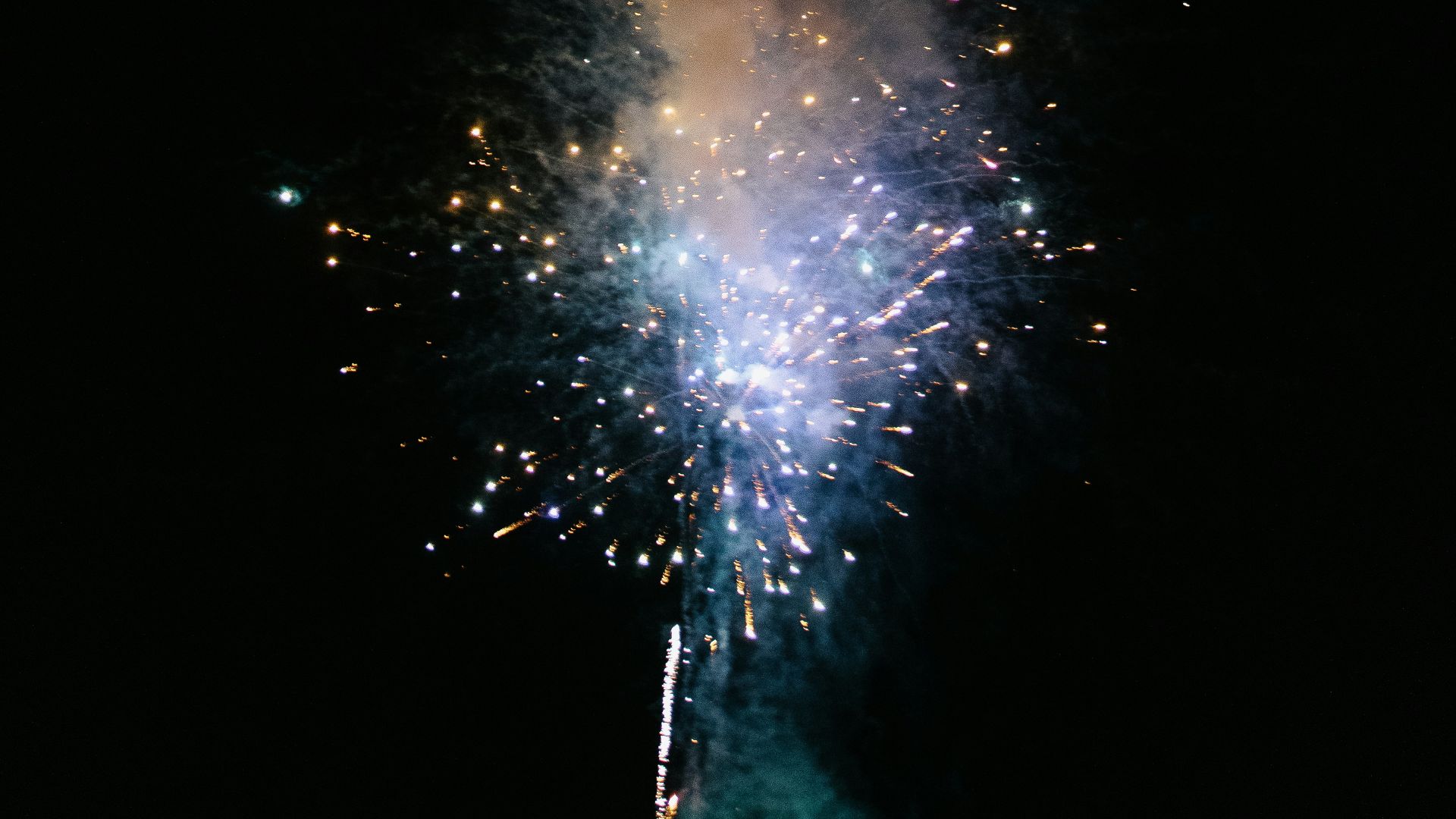 a fireworks is lit up in the dark sky