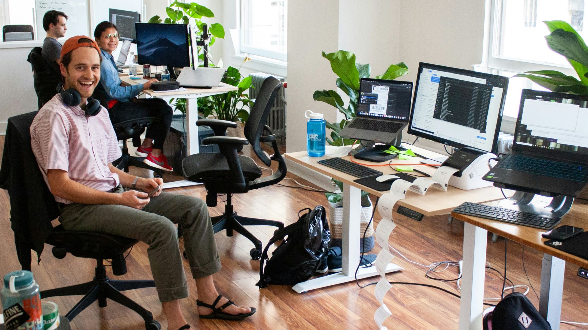 man in blue dress shirt sitting on black office rolling chair