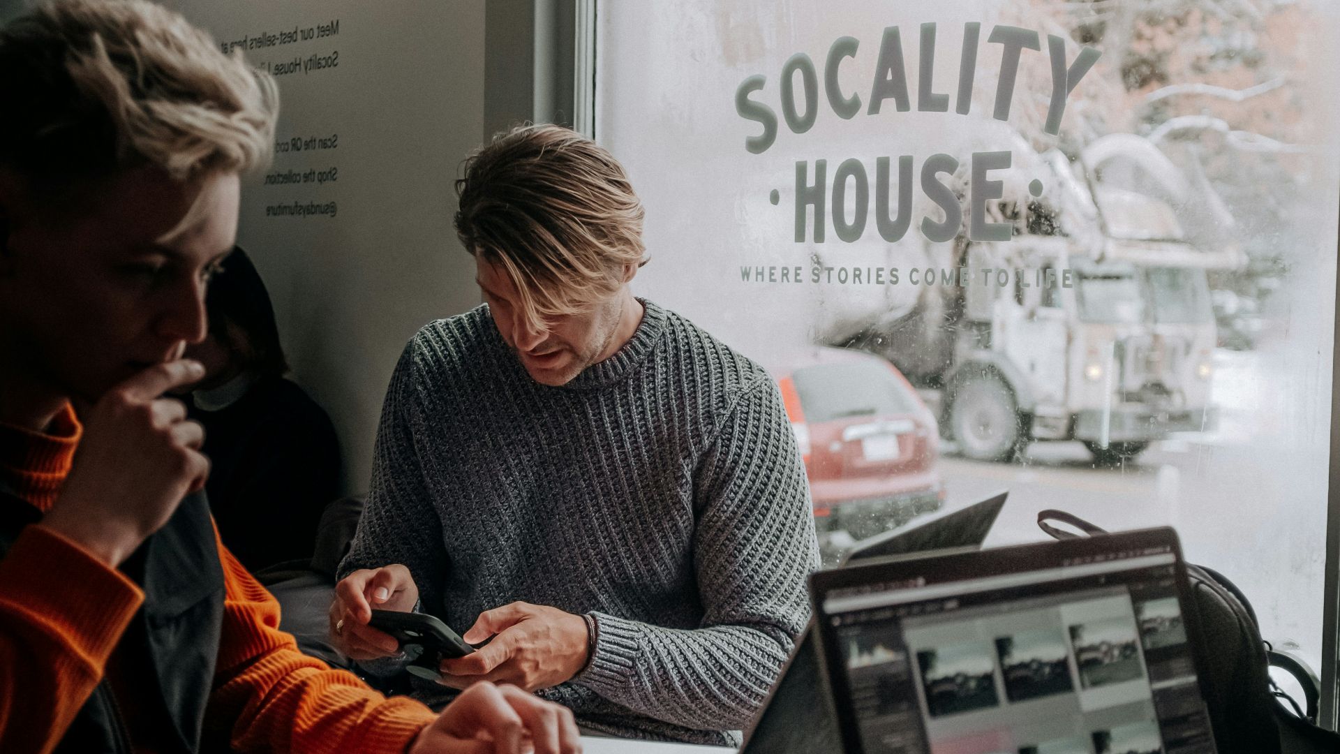 A group of people sitting at a table with laptops