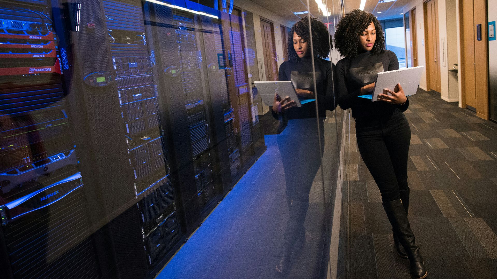 woman in black top using Surface laptop