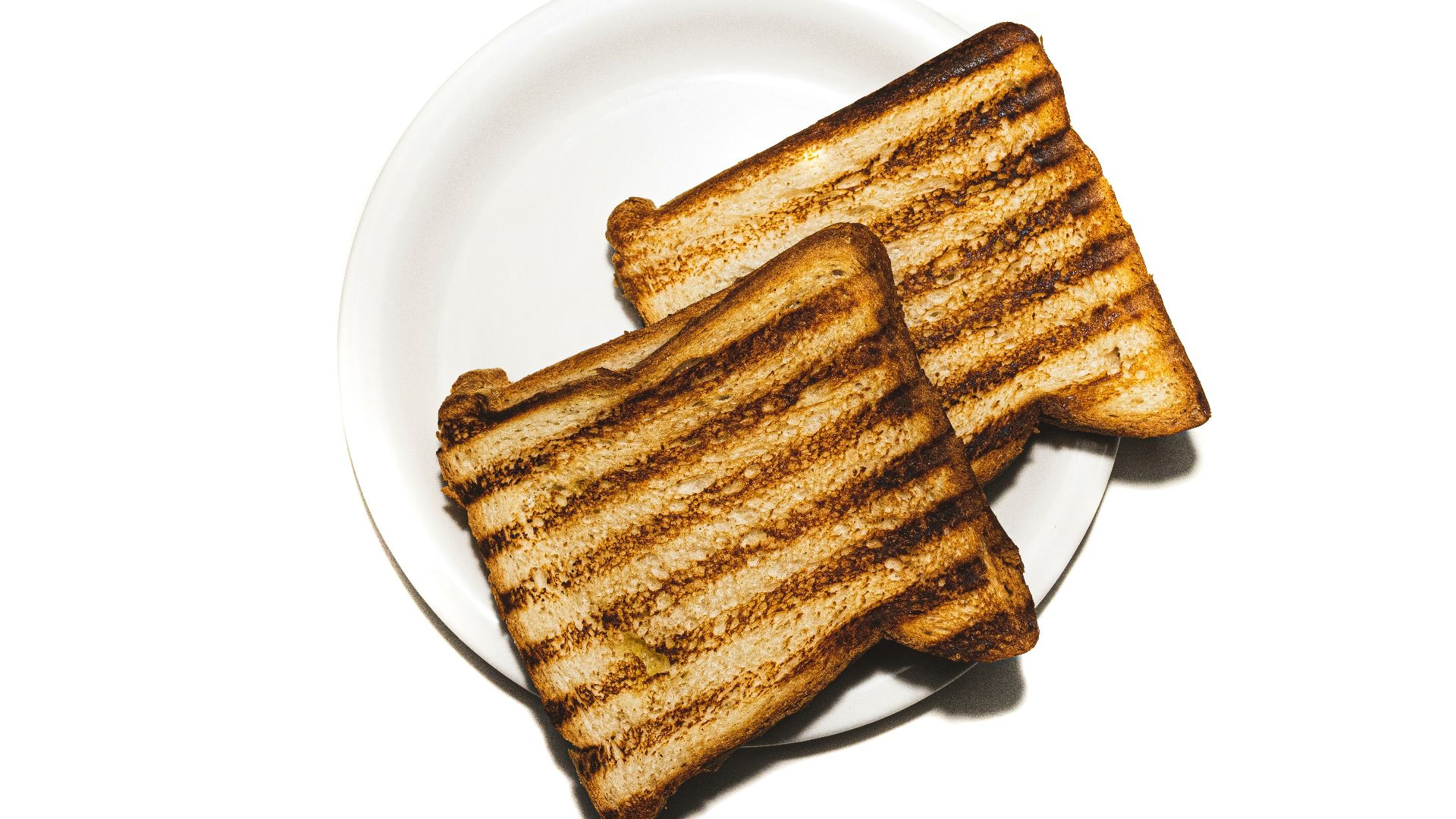 brown and black bread on white ceramic plate