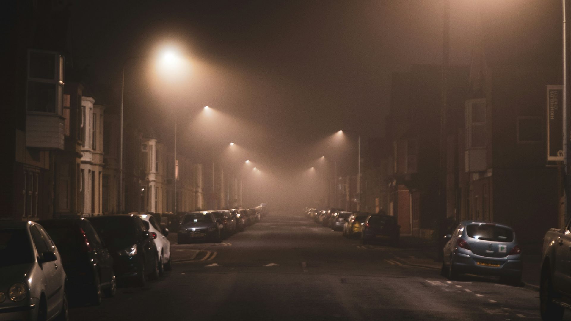 cars parked on side of the road during night time