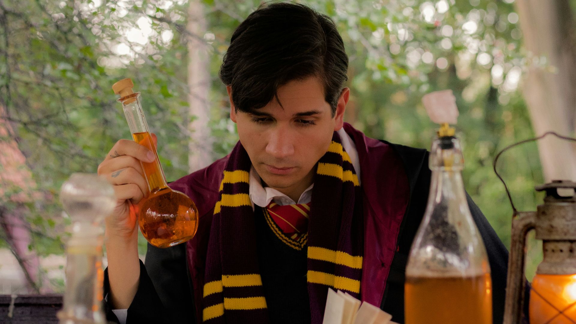 a person sitting at a table with a book and a bottle