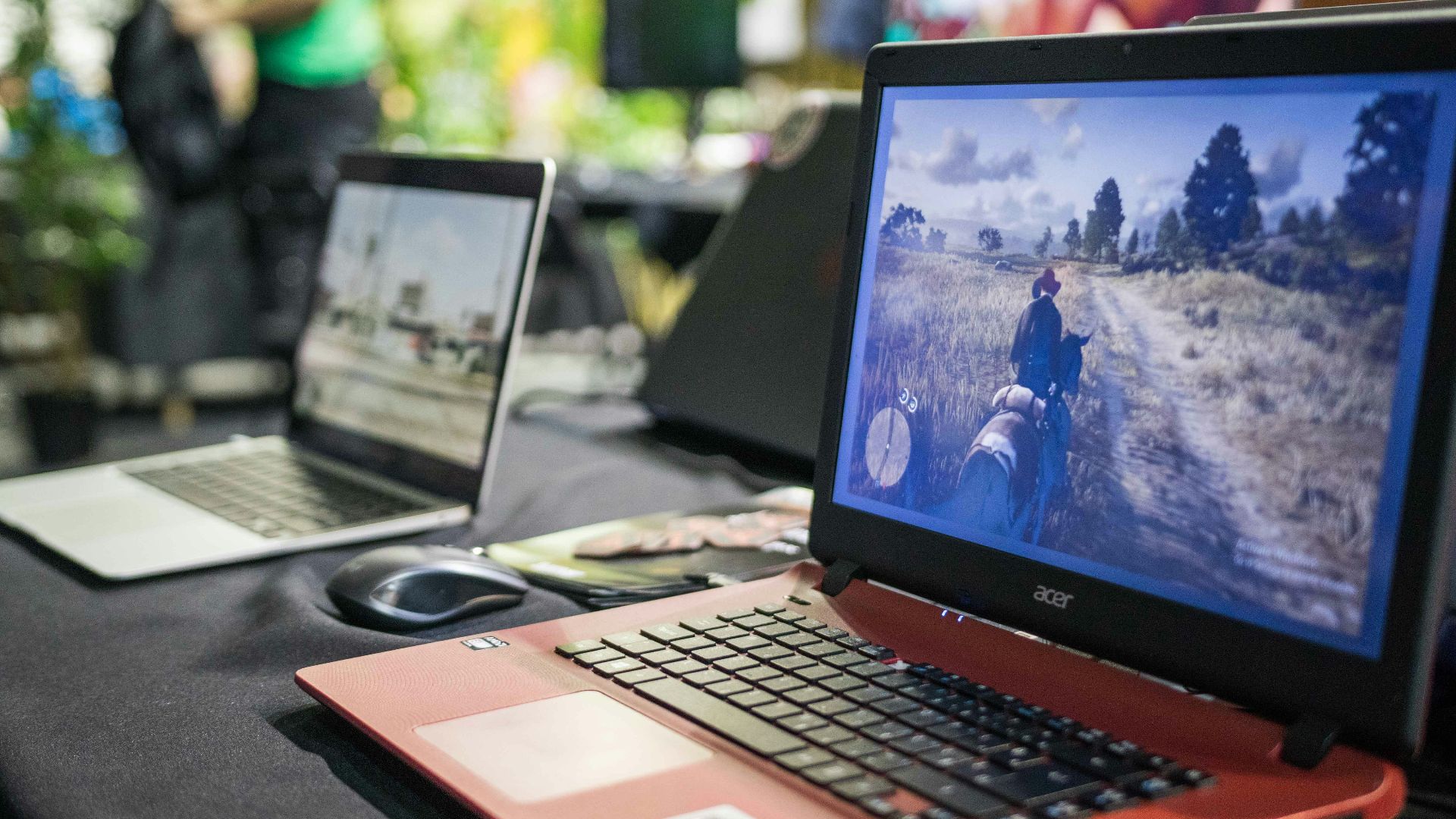 a couple of laptops sit on a table