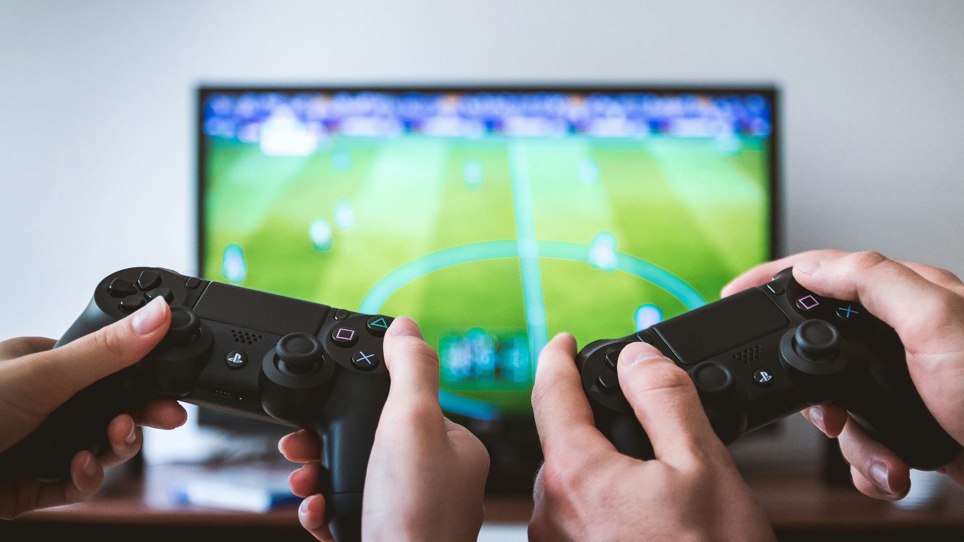 two people playing Sony PS4 game console