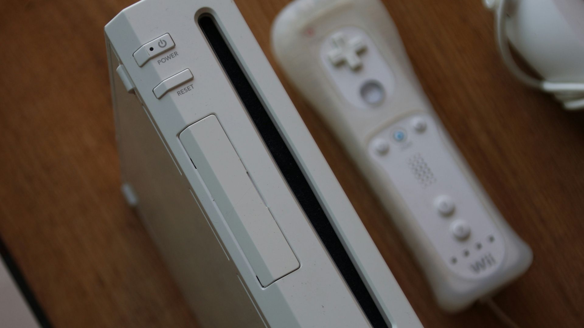 a nintendo wii game system sitting on top of a wooden table