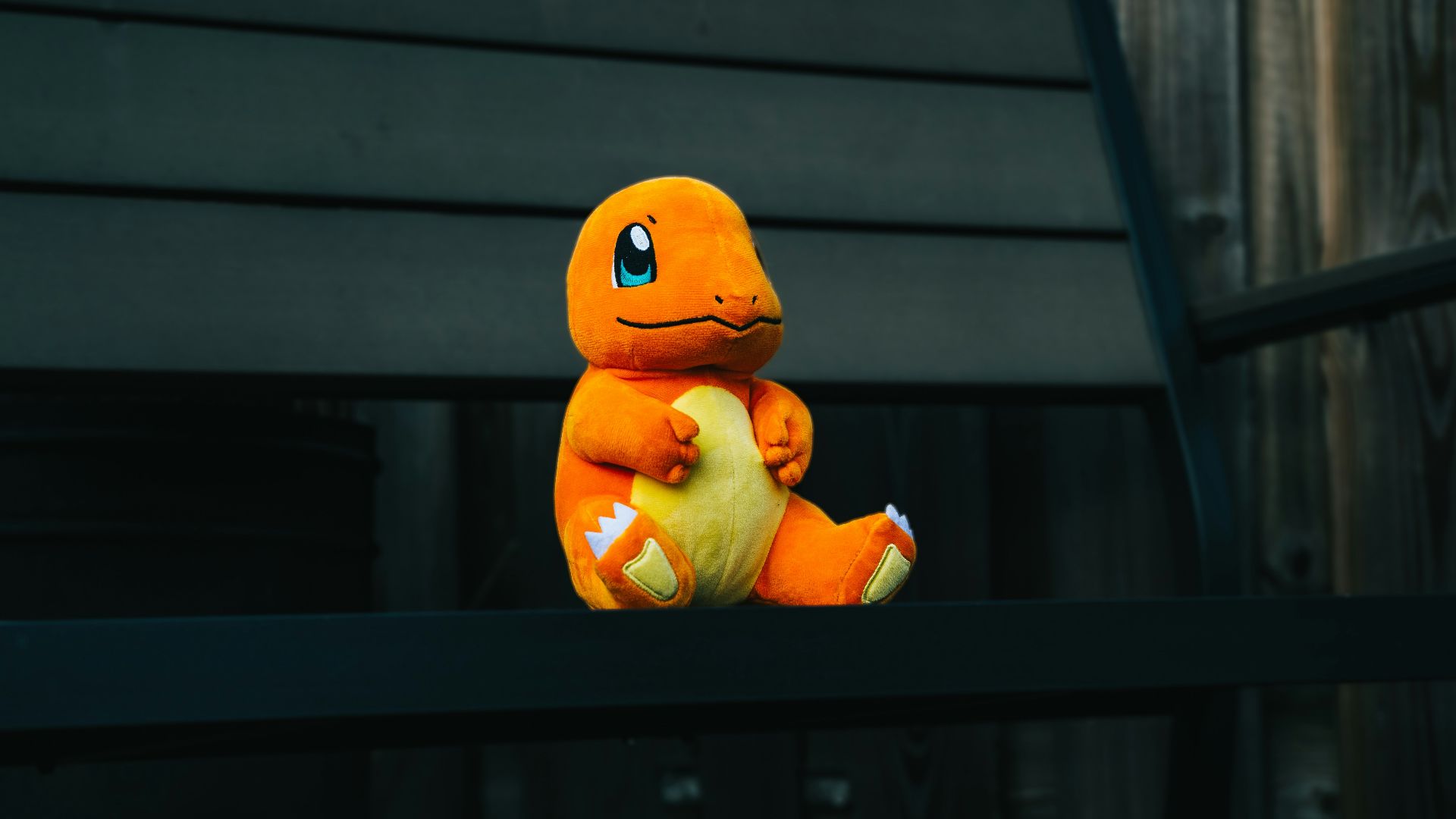 a stuffed toy sitting on top of a wooden bench