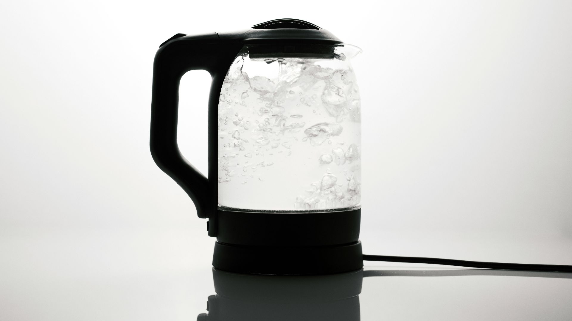 a black and white photo of a water kettle
