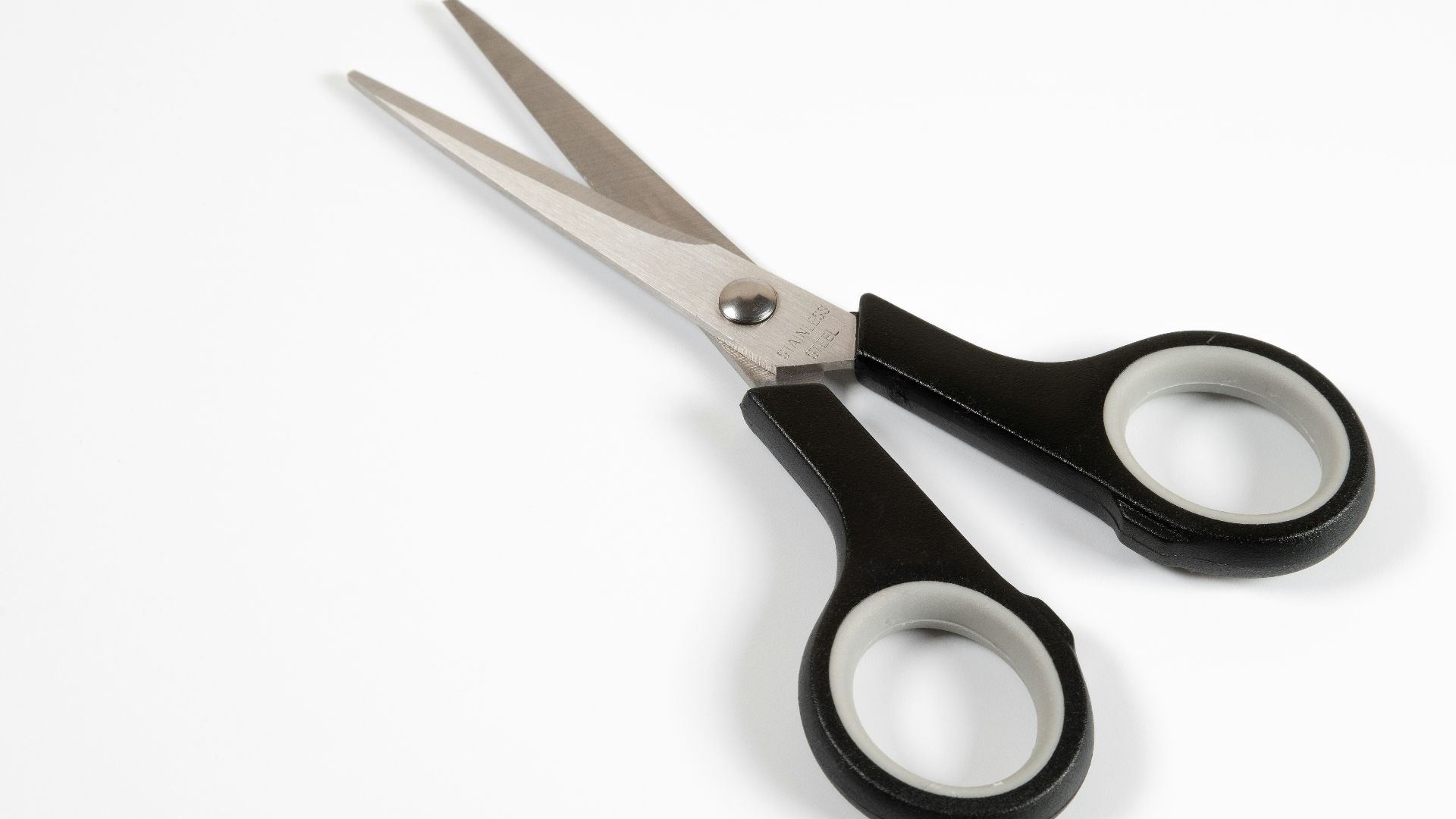 a pair of scissors sitting on top of a white table