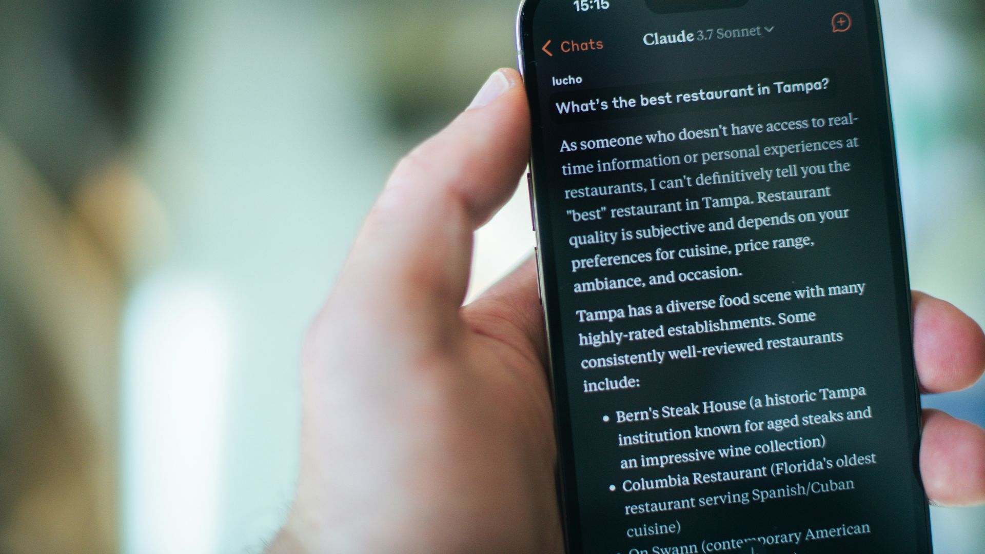 A person reads restaurant recommendations on their phone.