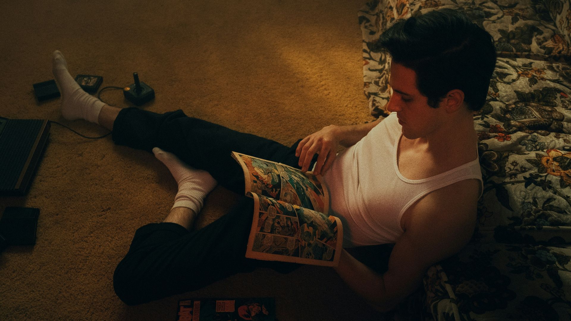 woman in white tank top and black pants sitting on brown carpet