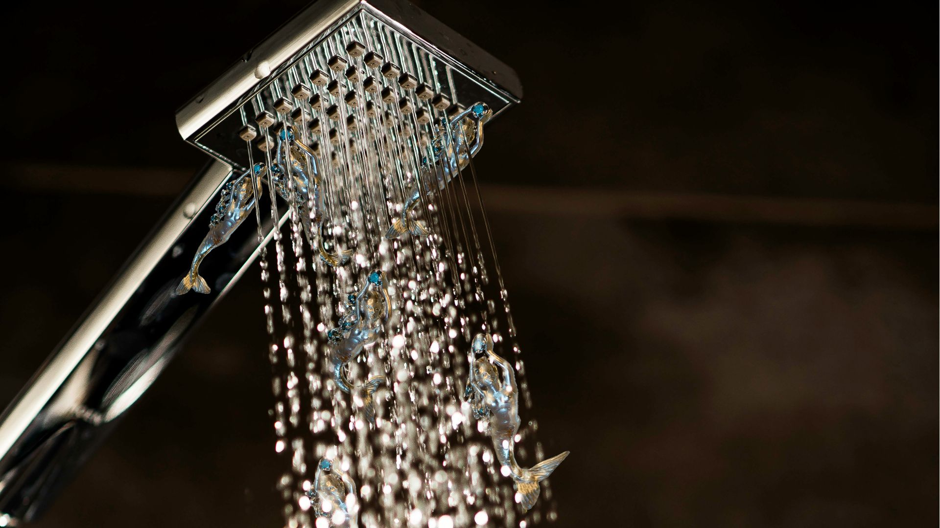 a close up of a shower head with water coming out of it