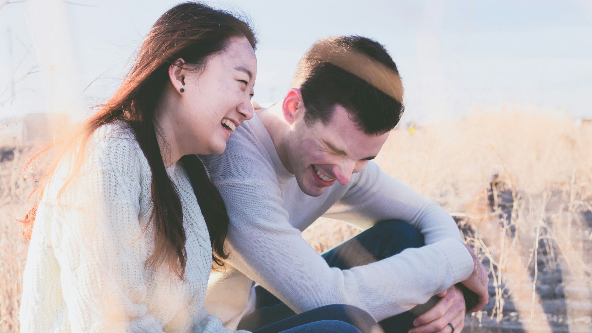 photo of man and woman laughing during daytime