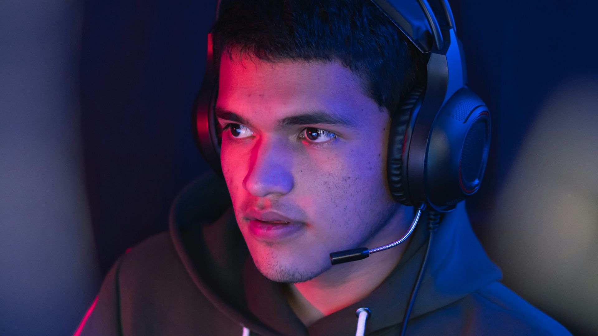 man in blue hoodie wearing black headphones