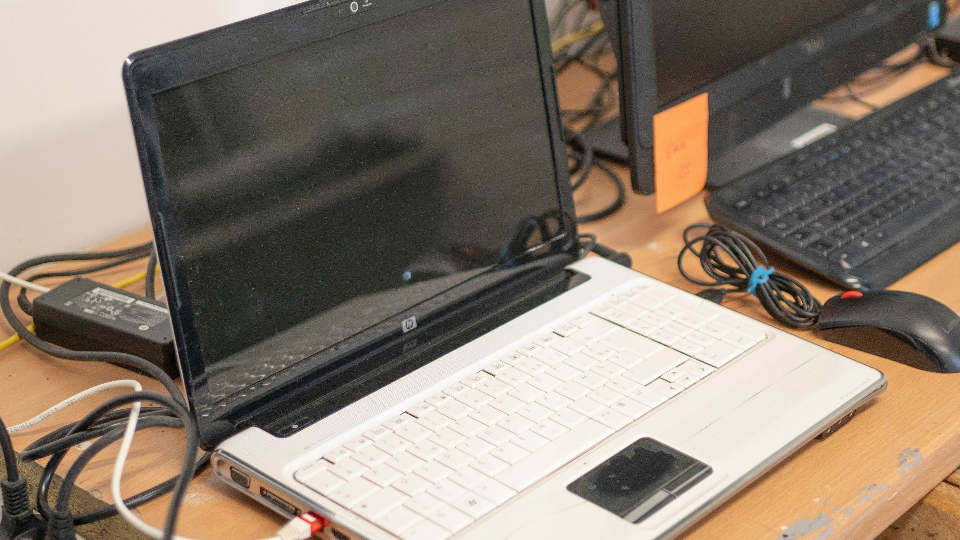 a desk with two laptops and a keyboard on it