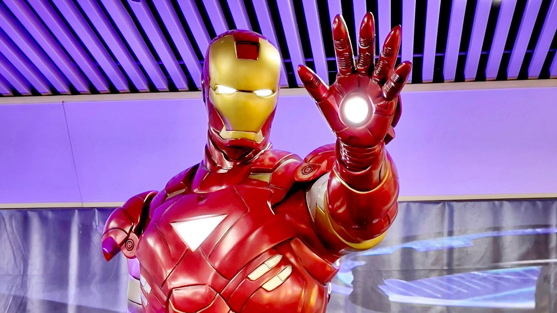 a statue of iron man is displayed in a museum