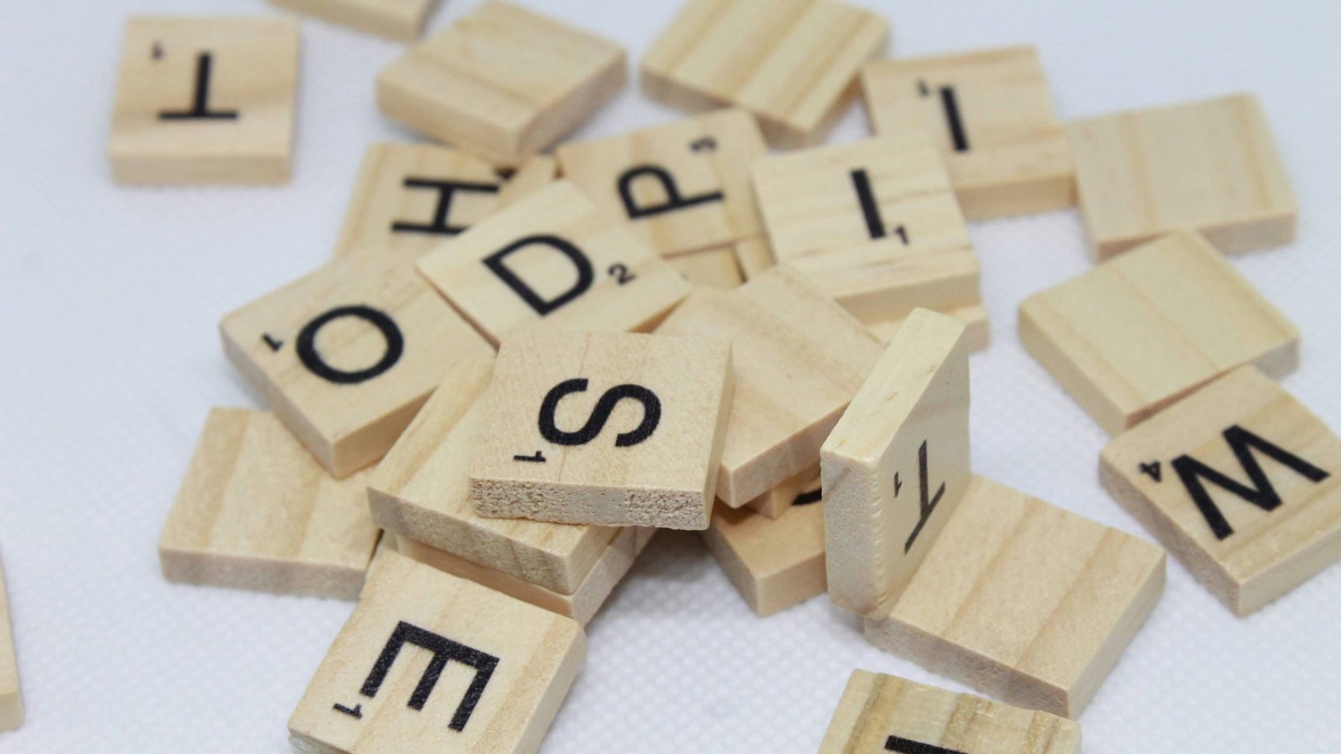 brown wooden letter blocks on white surface