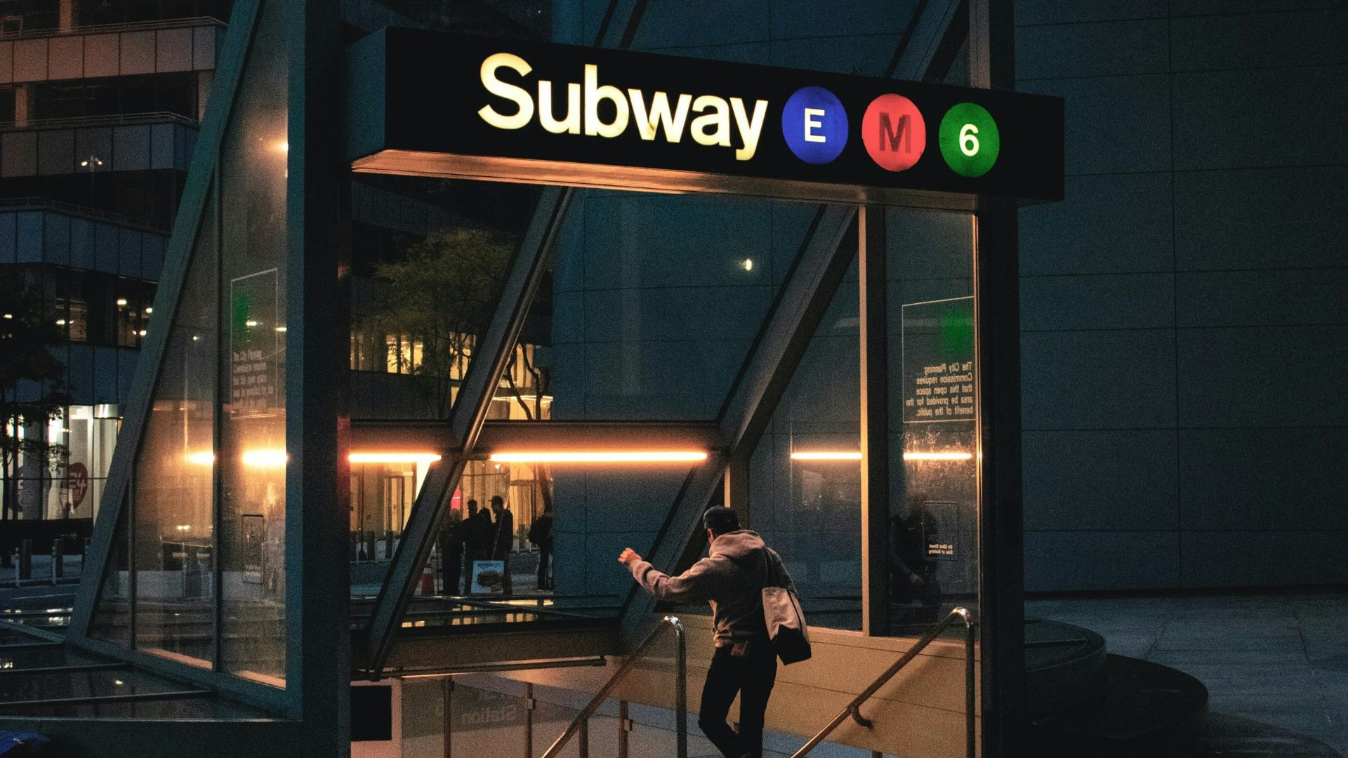 a man riding a skateboard into a subway entrance