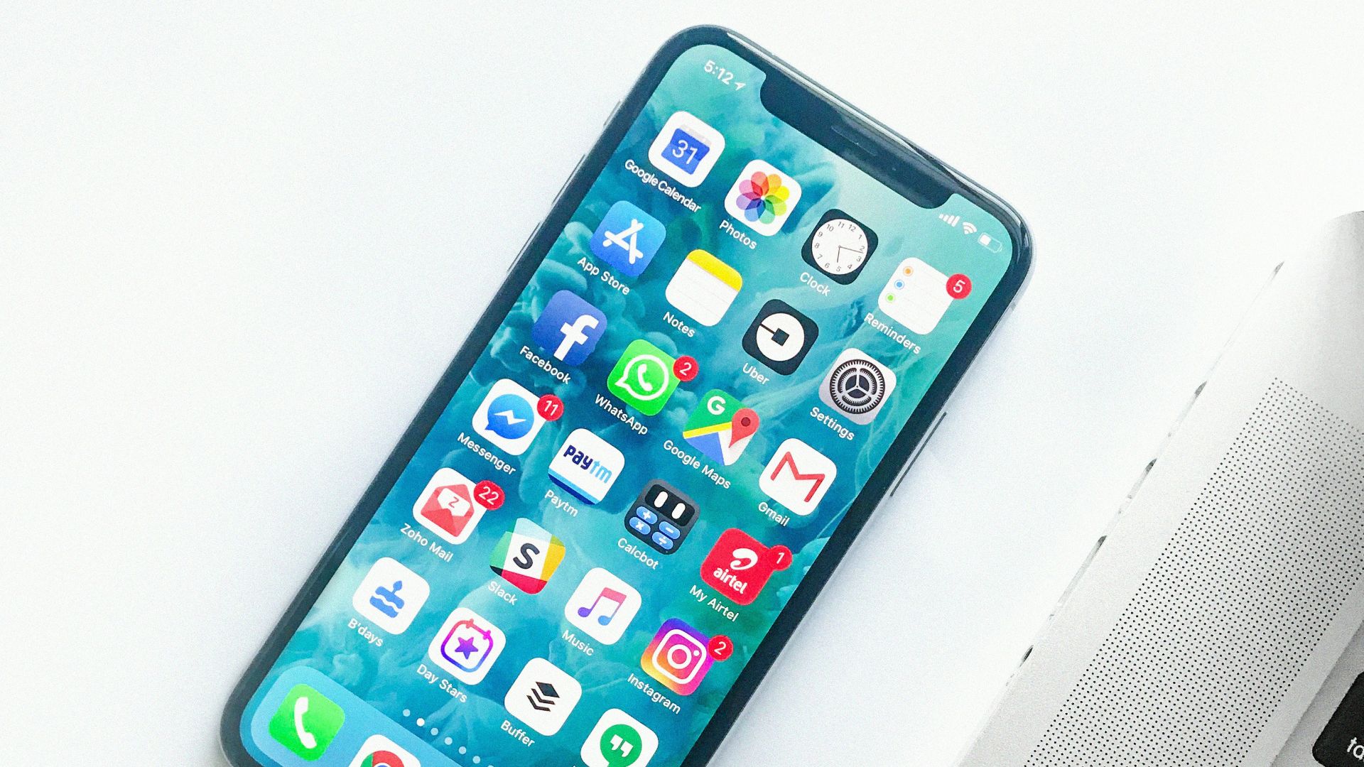 white smartphone near laptop