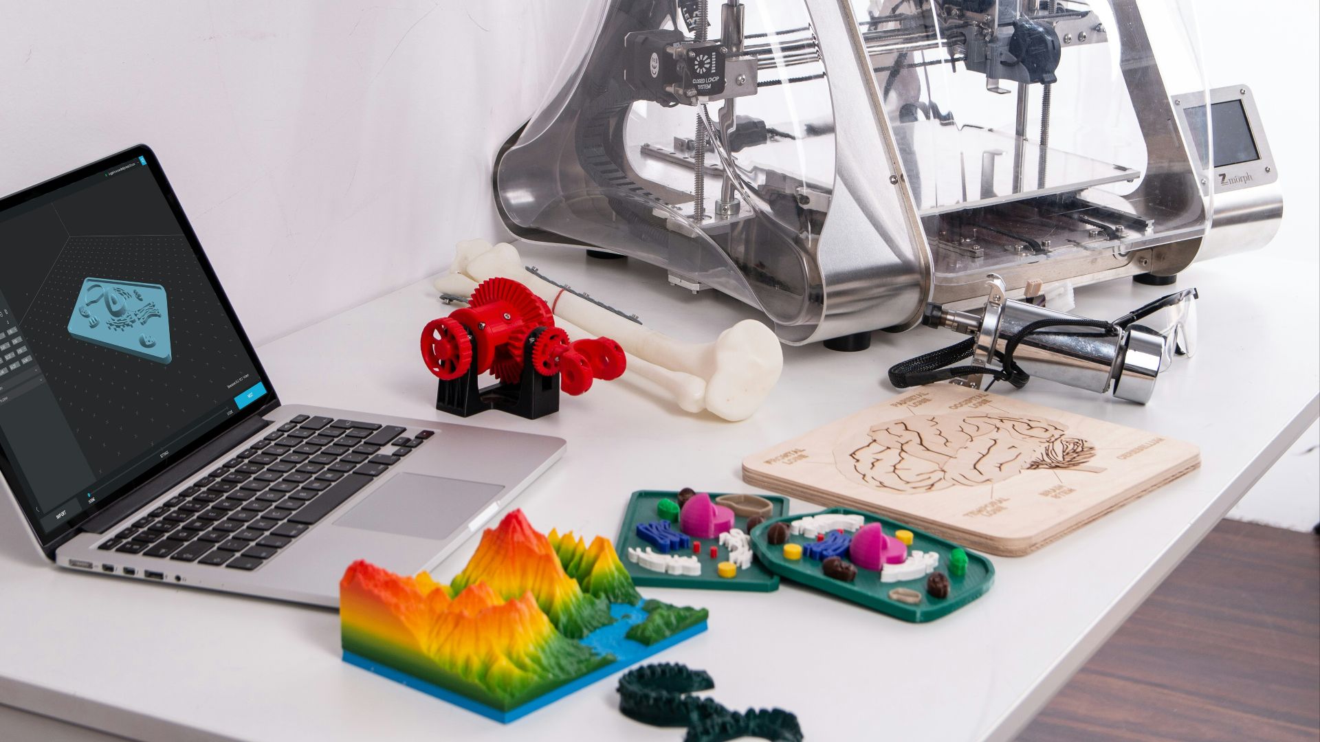 MacBook Pro beside 3D printer