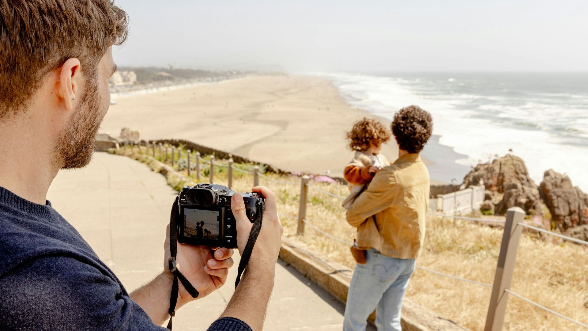 A man taking a picture of a woman with a camera