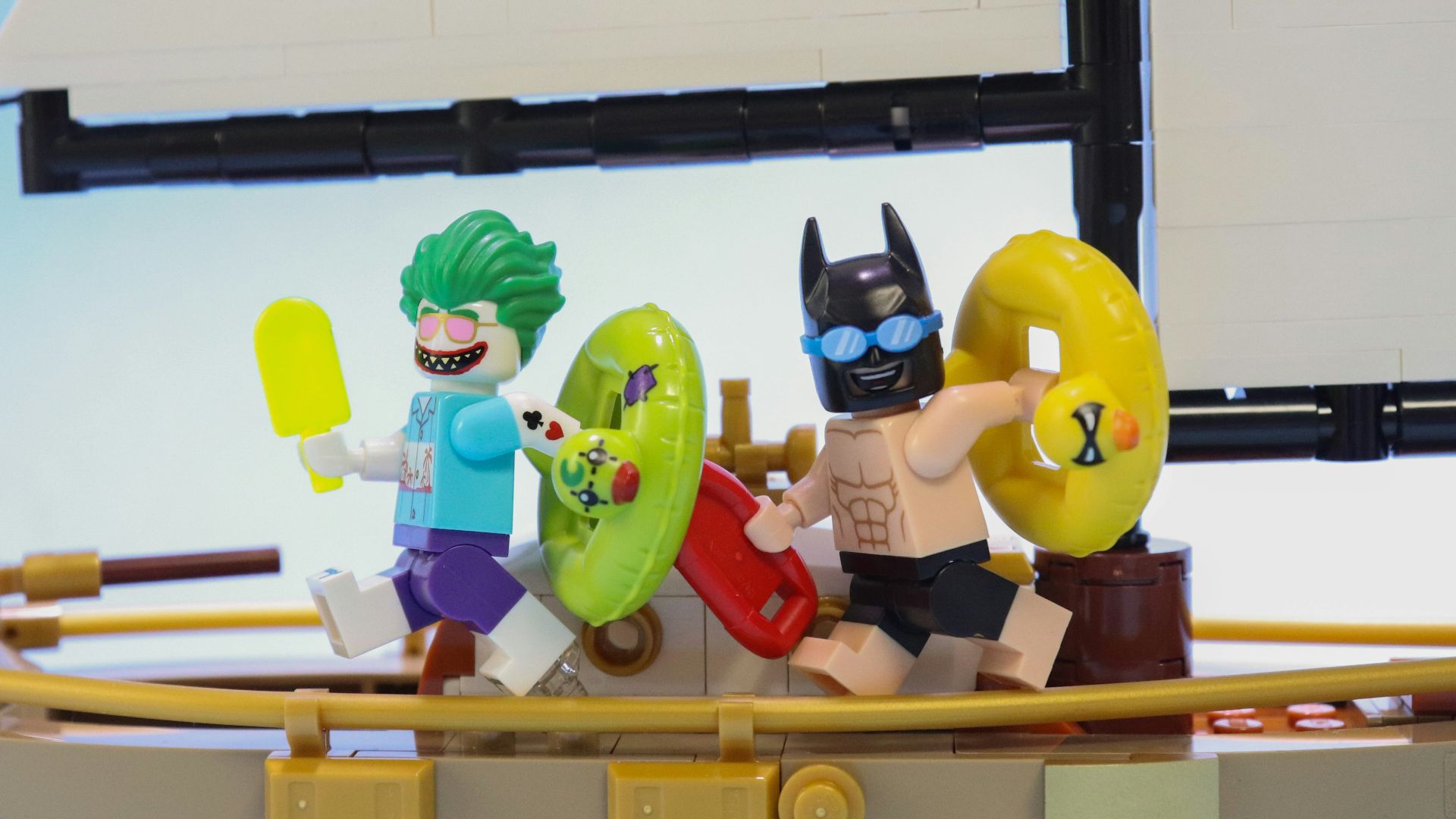 a lego boat with a batman and joker on it