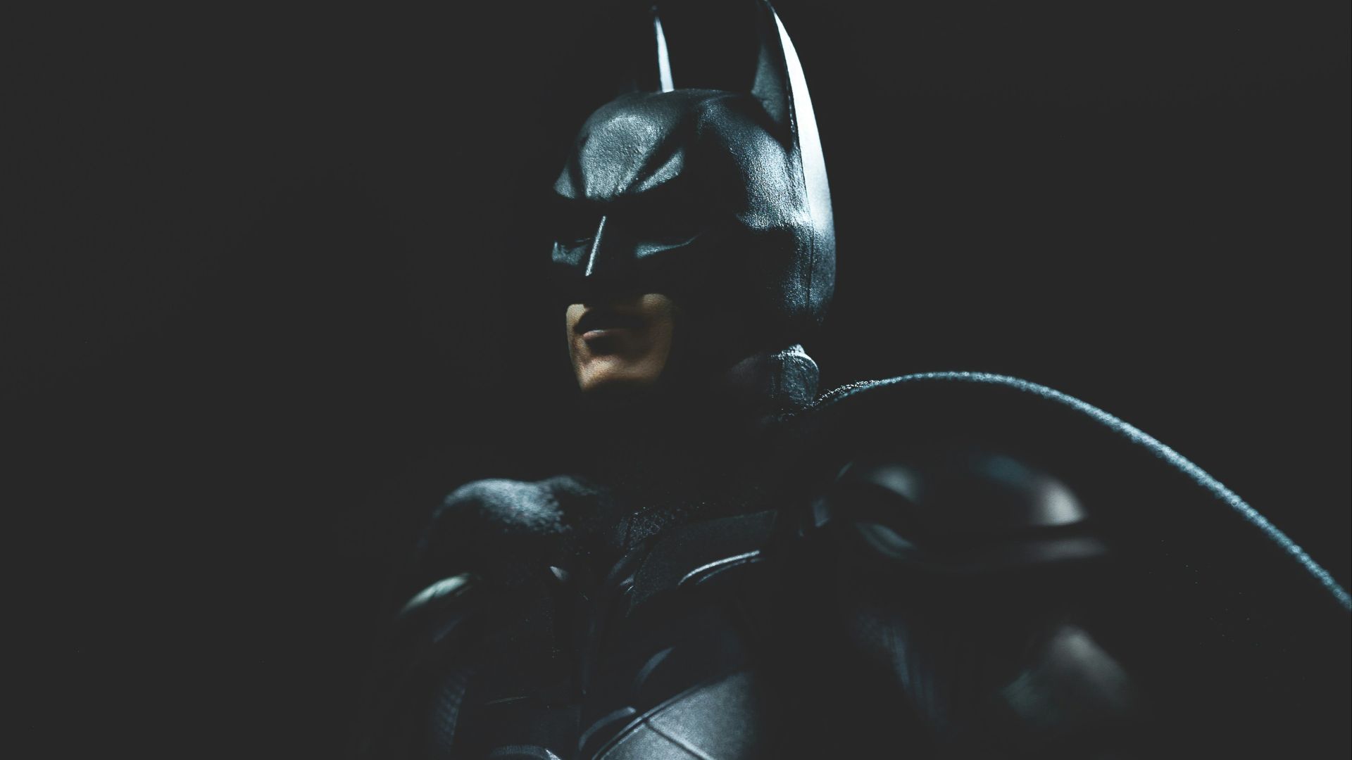 a man in a batman costume holding a bat