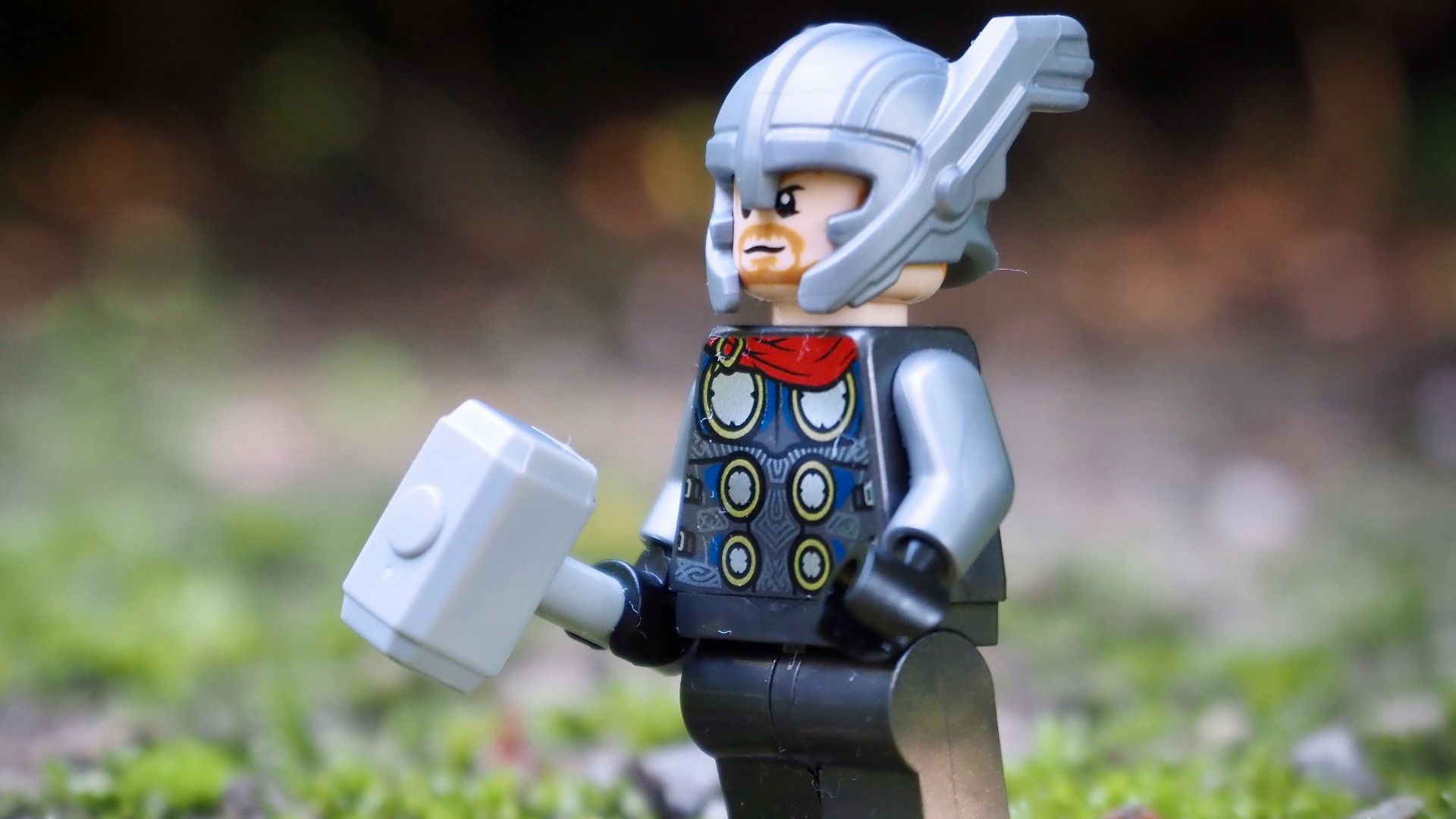 lego minifig on green grass during daytime