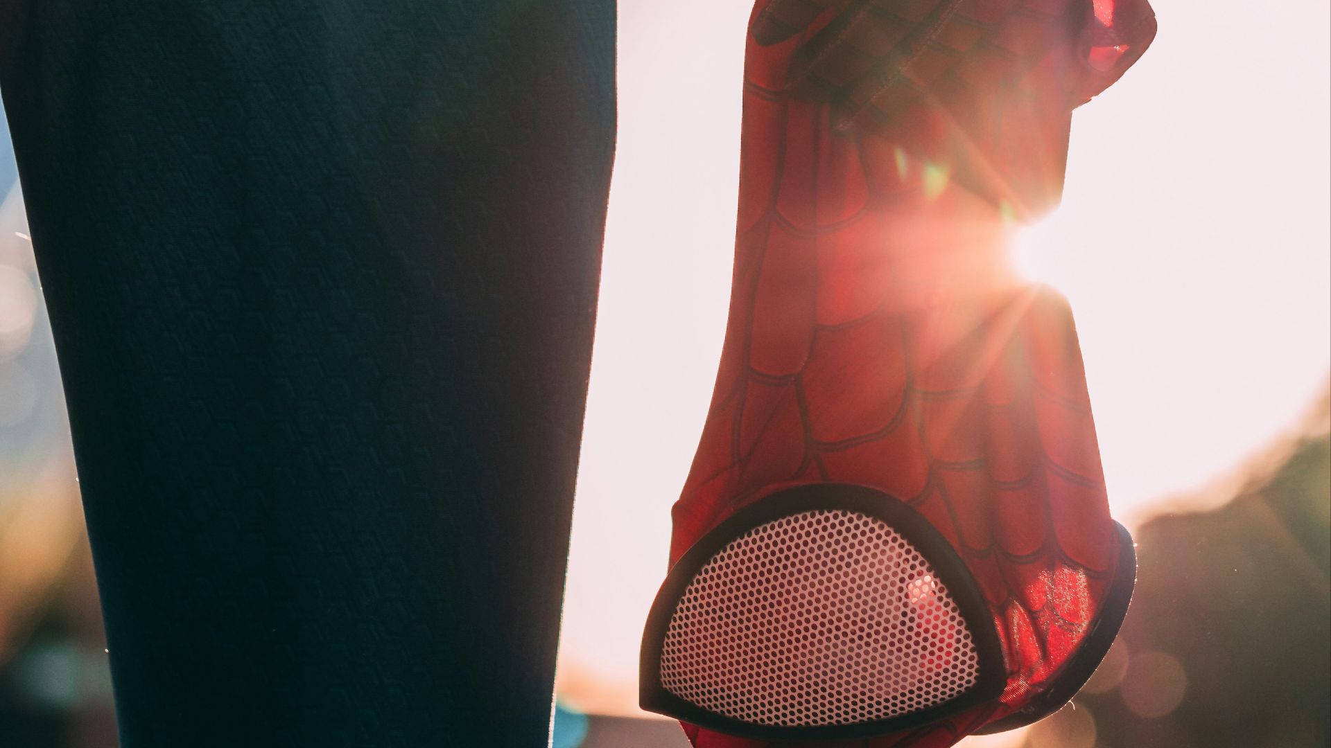 person holding Spider-Man mask