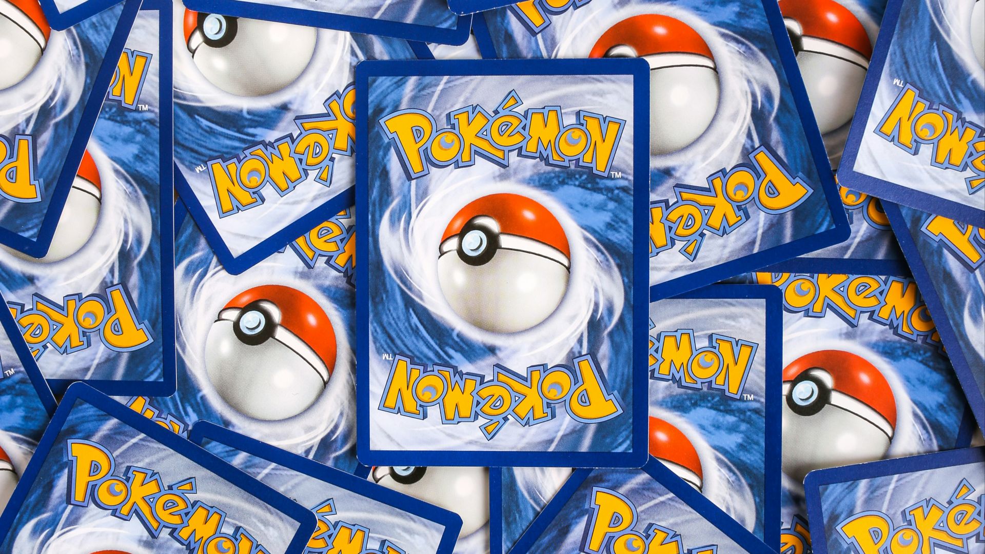 a pile of pokemon trading cards sitting on top of each other