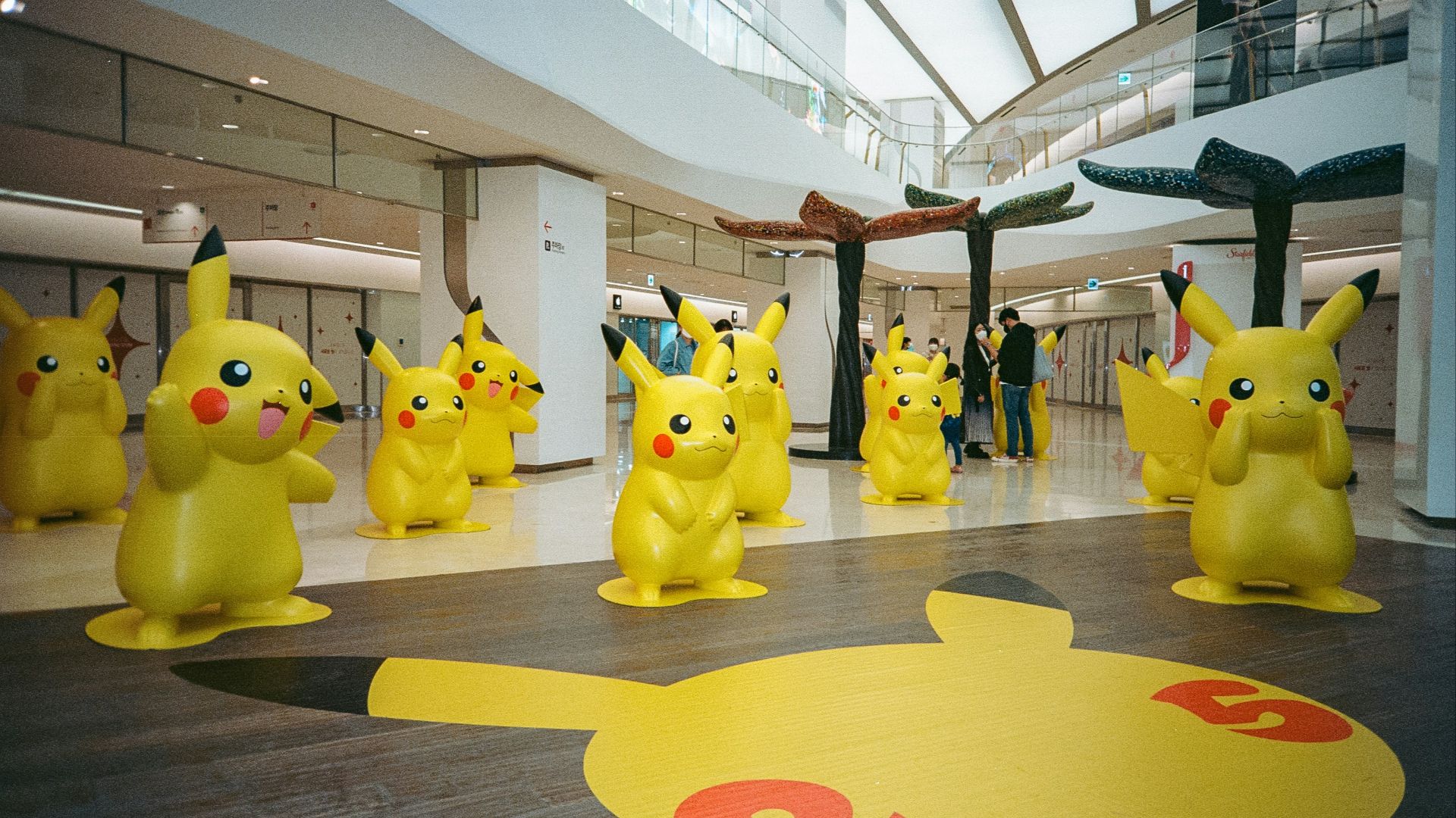 a group of pikachu statues in a building