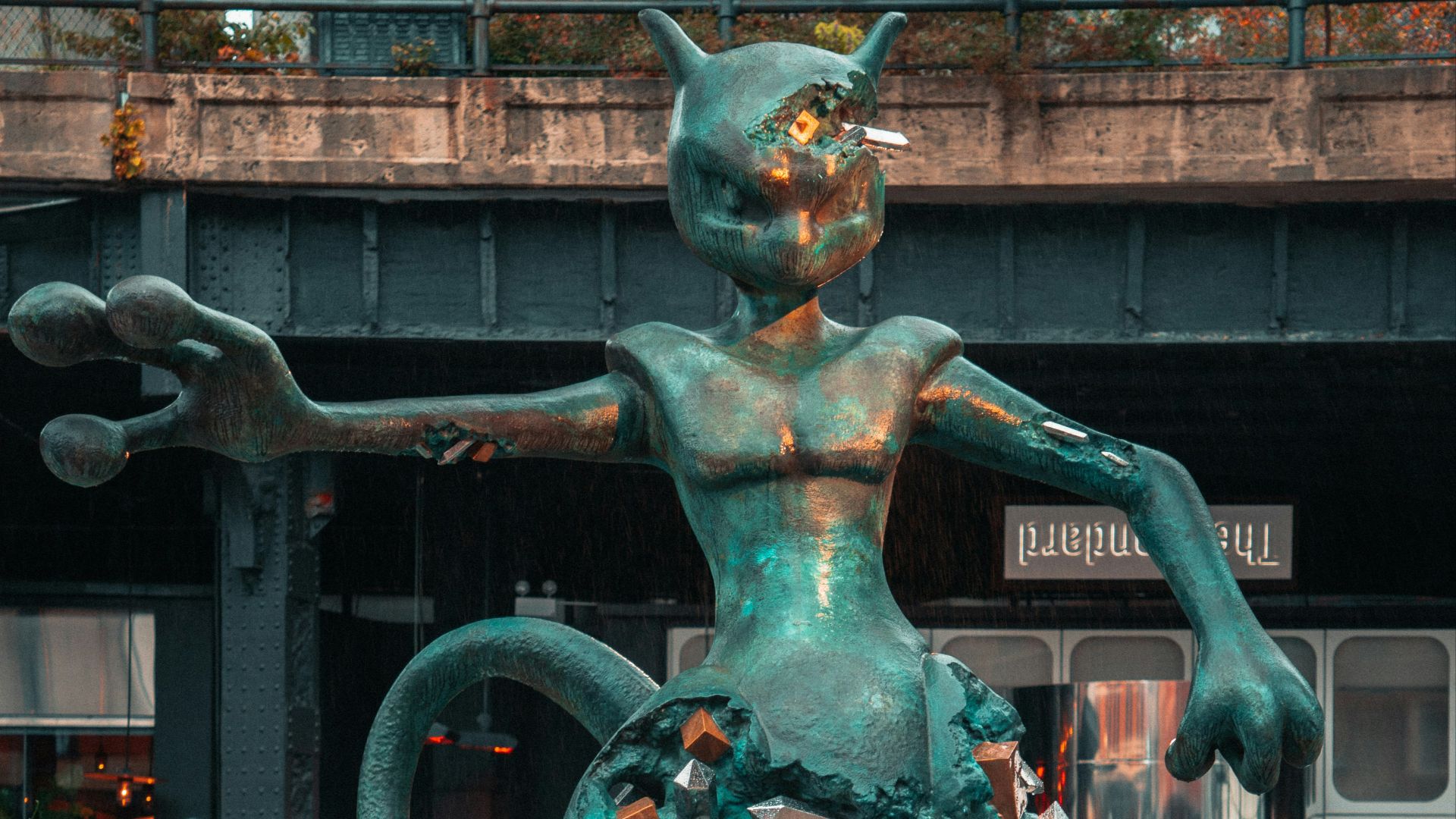 a statue of a man riding a cat in front of a building