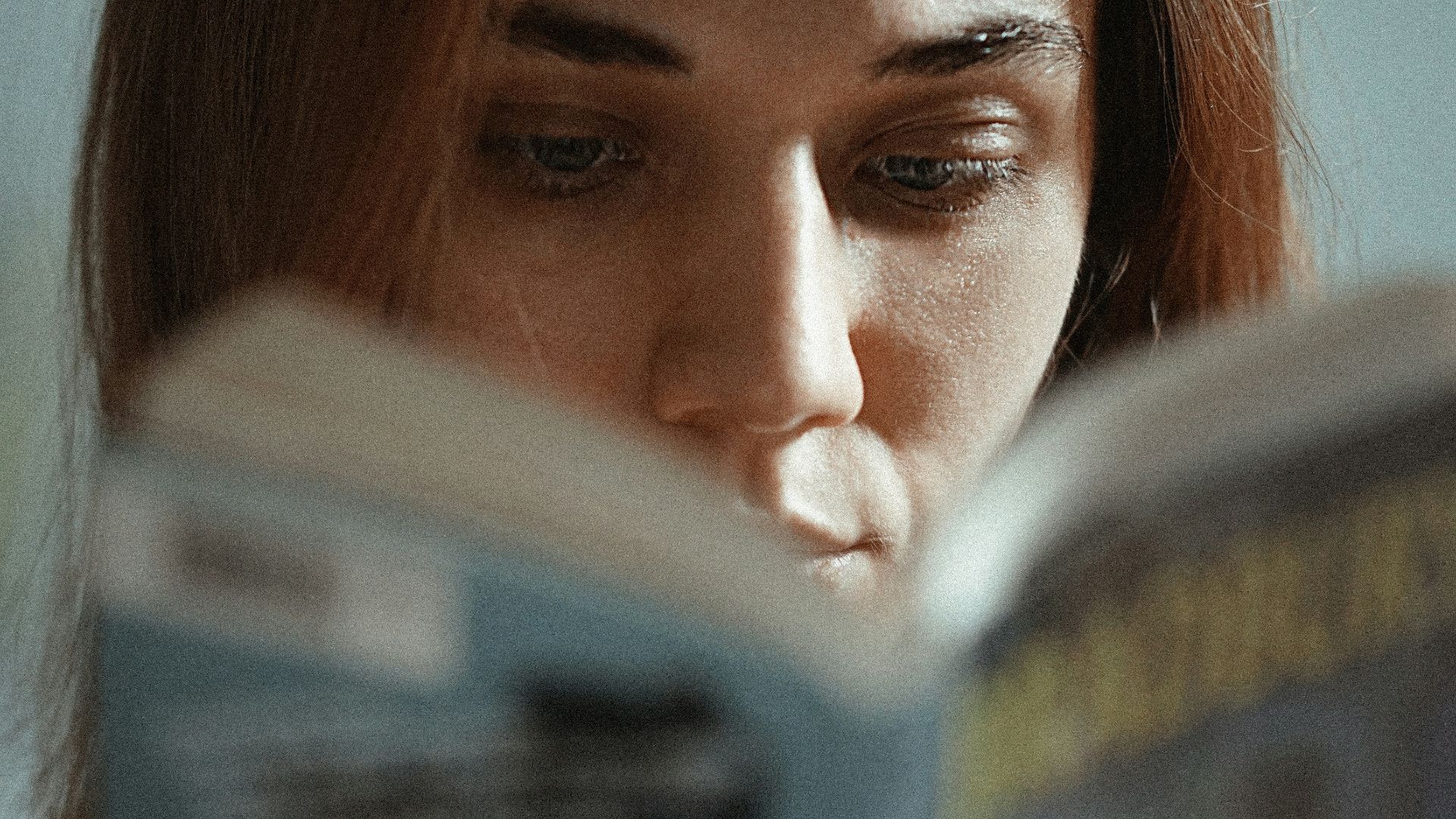 woman holding magazine with womans face