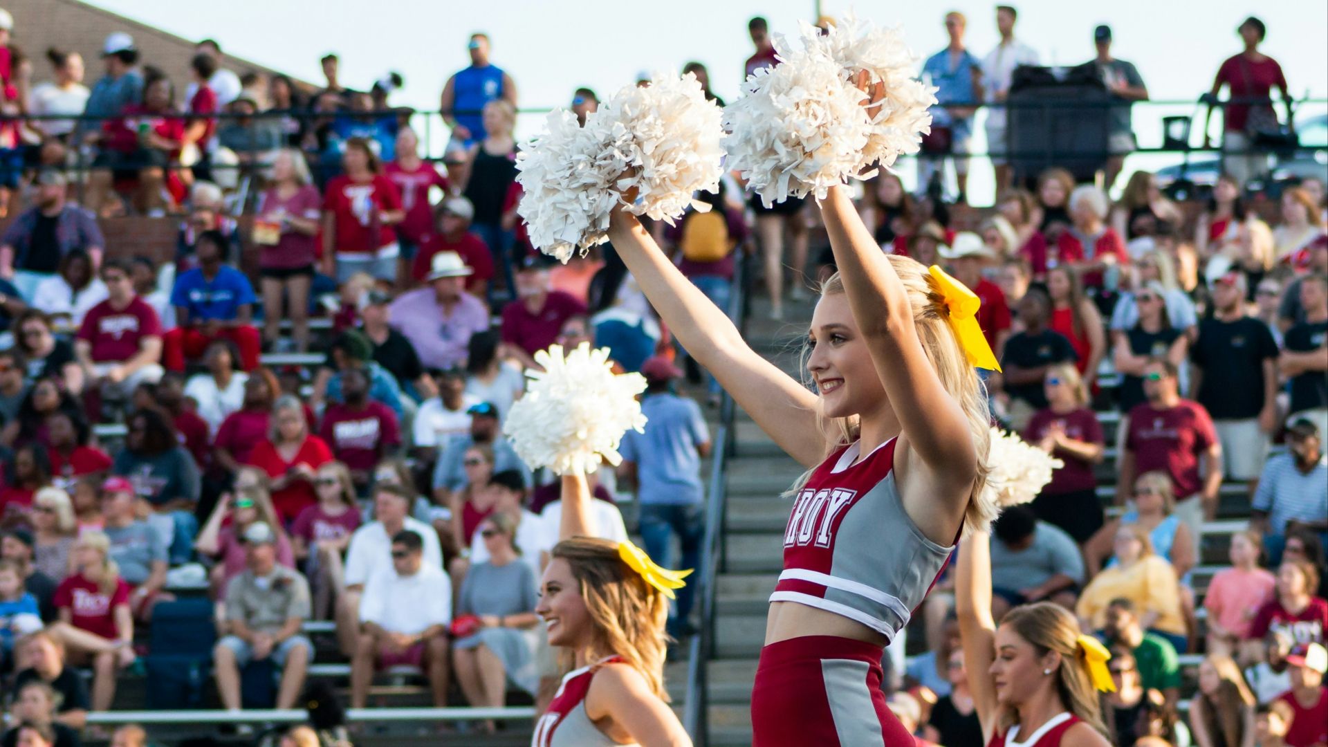 women in white and red uniform dancing on stage during daytime