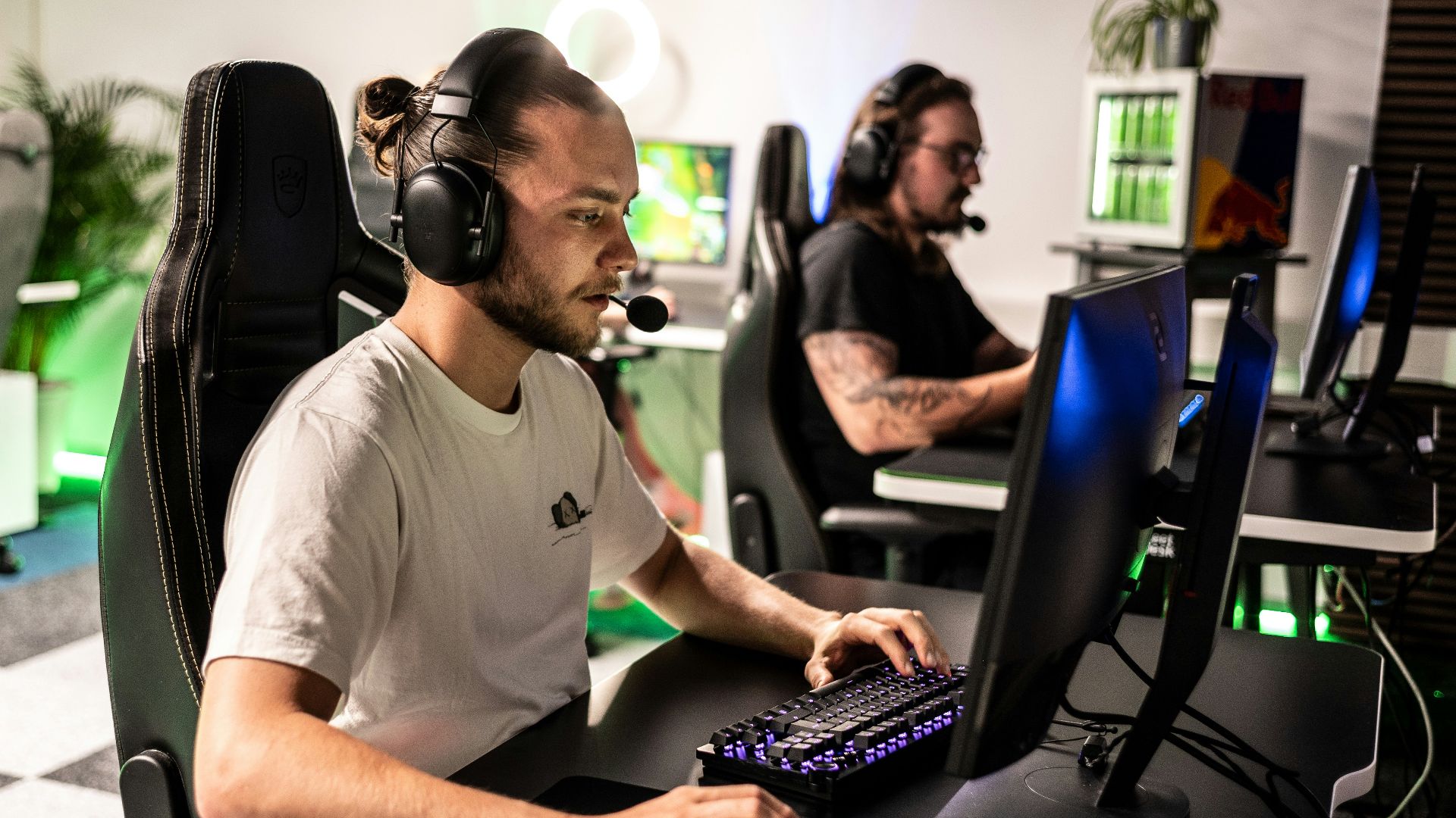 A man sitting at a computer with headphones on