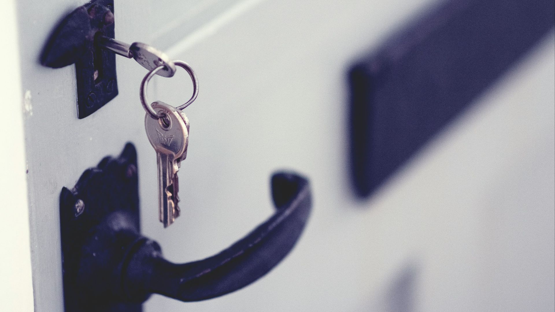 black and silver padlock on white door