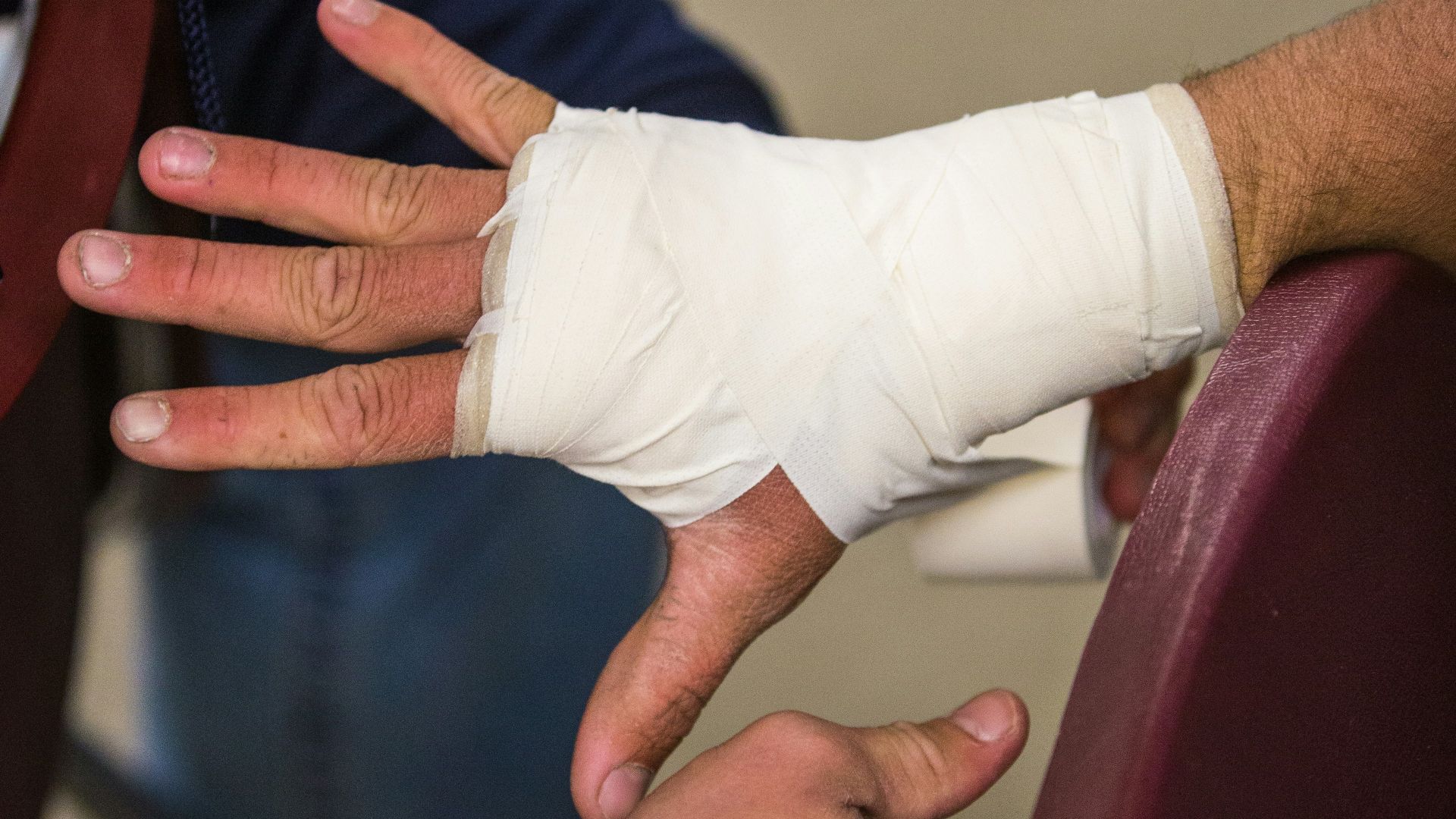 person in white gloves holding persons hand