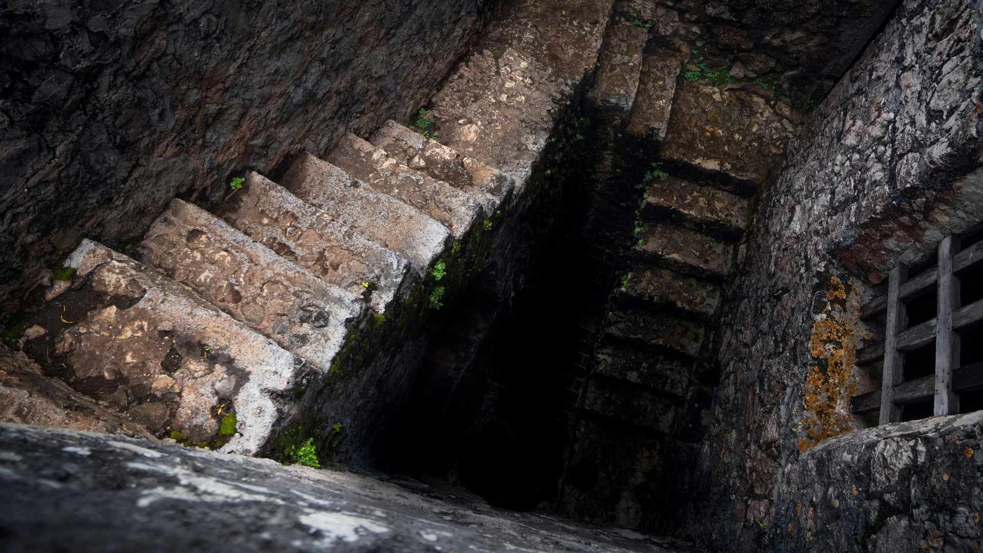 a stone building that has a rocky cliff