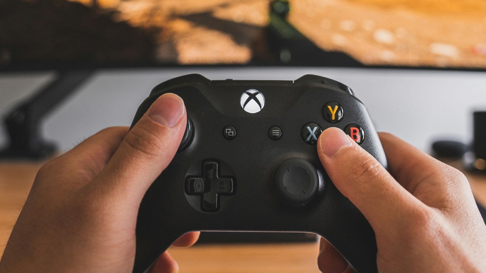 person holding black game controller